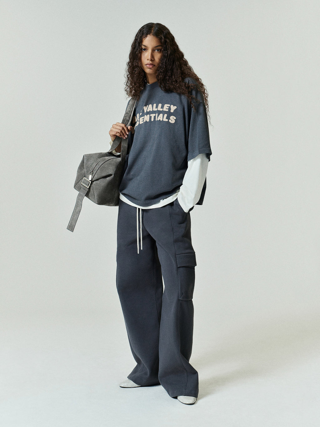 Womens Fleece Cargo Relaxed Sweatpant in a deep iron grey hue featuring wide legs, a drawstring waist, and large side cargo pockets for laid-back, functional casual bottoms.