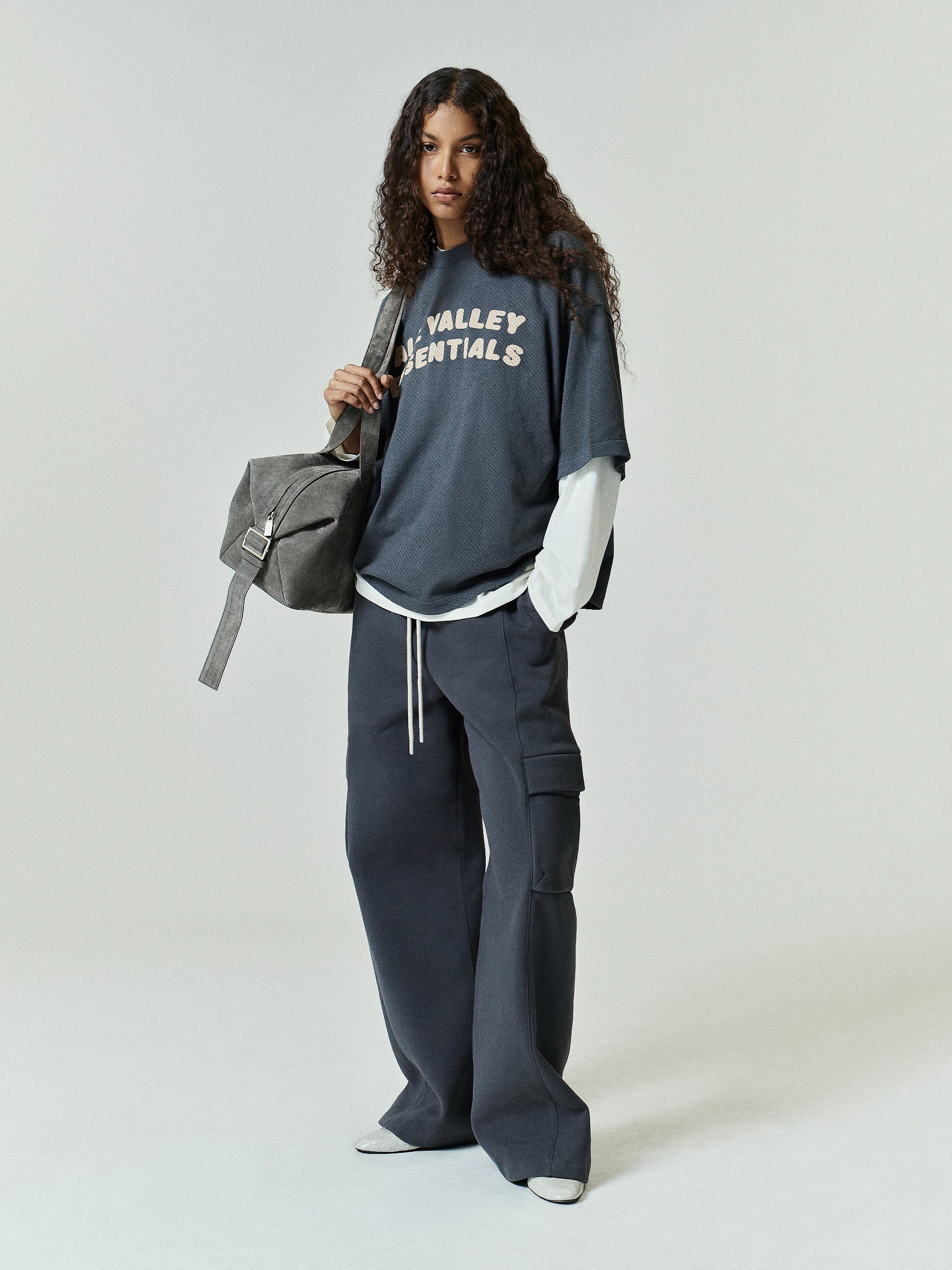 Womens Fleece Cargo Relaxed Sweatpant in a deep iron grey hue featuring wide legs, a drawstring waist, and large side cargo pockets for laid-back, functional casual bottoms.
