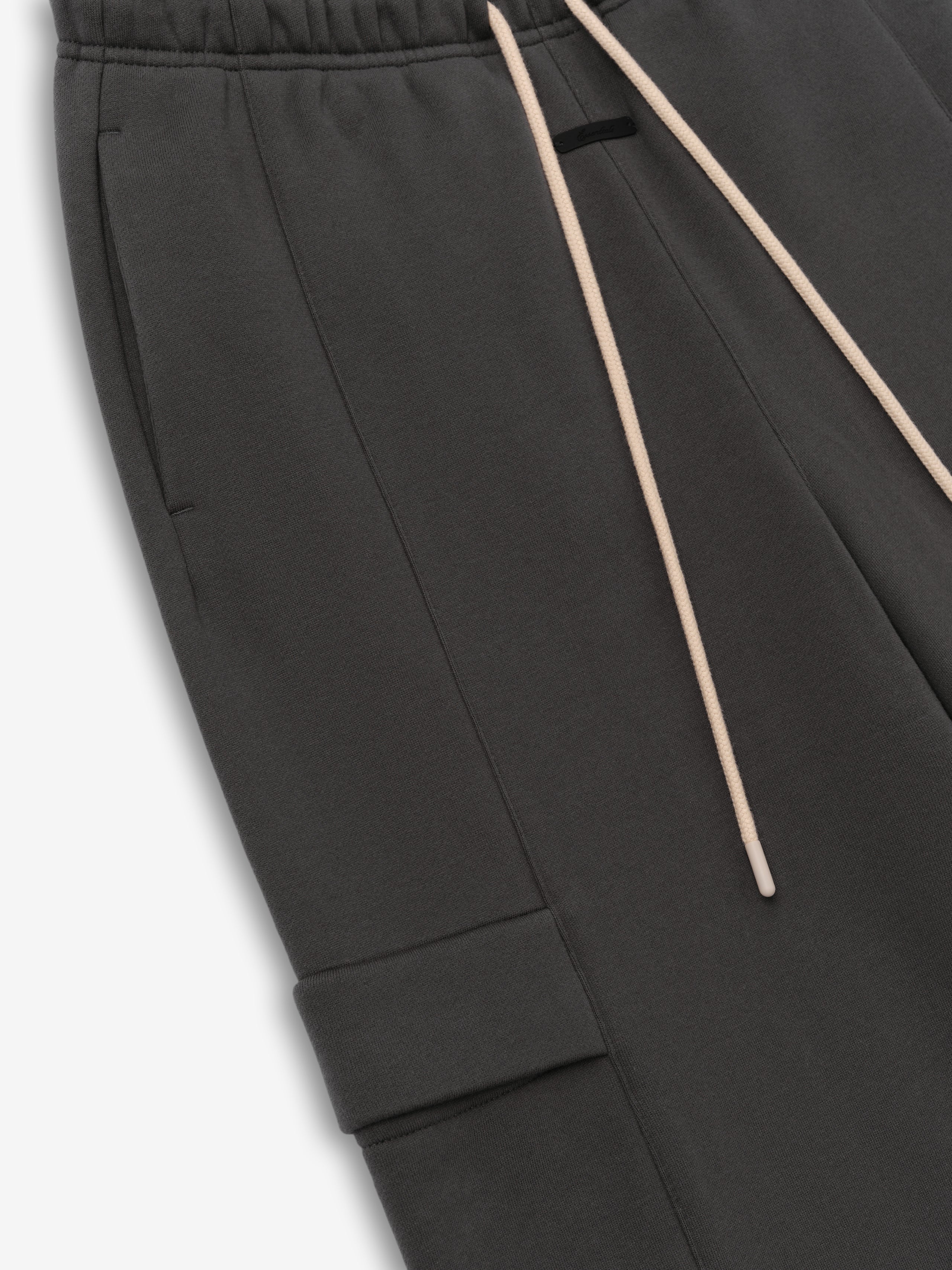 Womens Fleece Cargo Relaxed Sweatpant in a muted iron grey with soft fleece fabric, featuring an elastic waistband, beige drawstrings, side seam pockets, and a flap cargo pocket for comfortable casual bottoms.