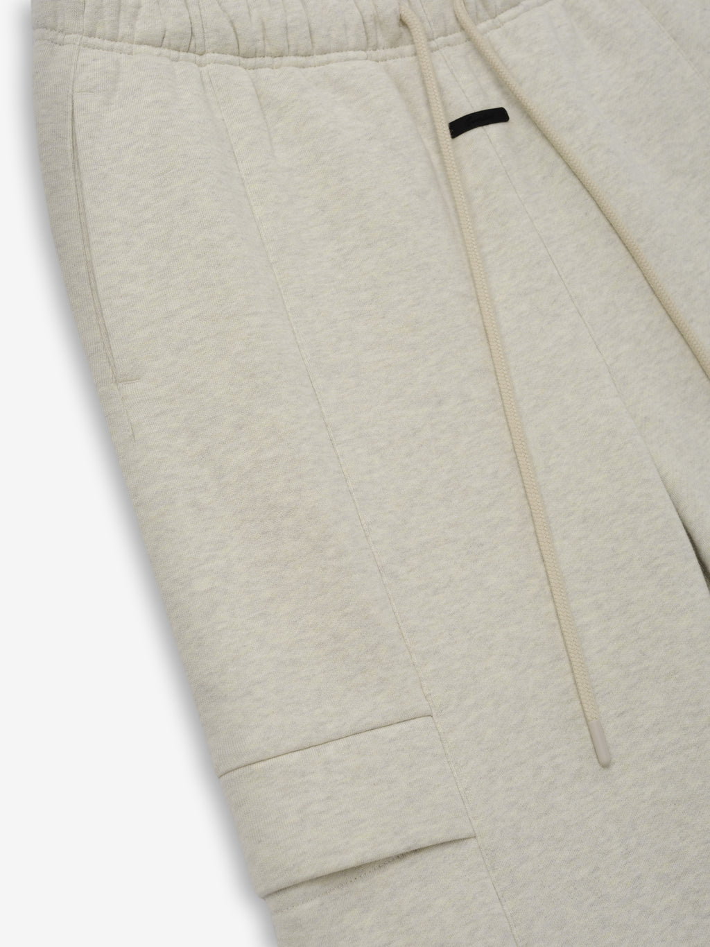 Womens Fleece Cargo Relaxed Sweatpant in a light oatmeal tone featuring soft fleece fabric, an elastic waistband with matching drawstring, side seam pockets, and a flap cargo pocket for casual comfort.