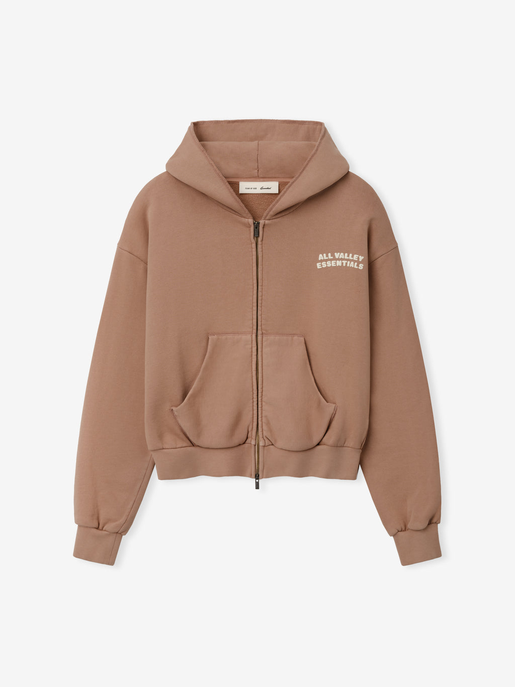 Womens 90s Full Zip Hoodie in a muted ginger tone featuring a relaxed fit, front pockets, ribbed cuffs, and subtle white text on the chest for casual outerwear style.