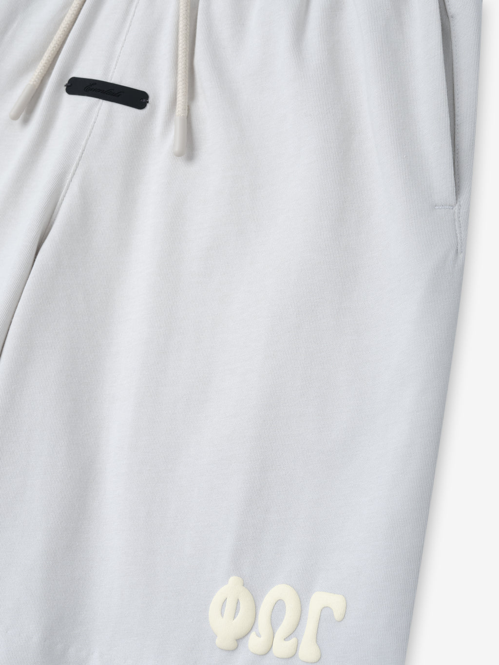 Kids 90'S Jersey Sweatshort in a soft light overcast shade, featuring an elastic waistband with drawstring and a subtle raised cream design near the hem, perfect for casual bottoms.