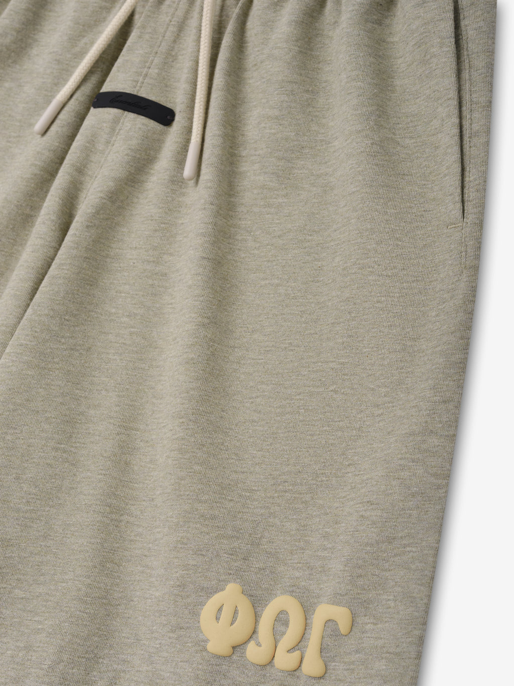 Kids 90'S Jersey Sweatshort in a soft seal heather color with a relaxed fit, adjustable drawstring waistband, side pockets, and raised textured branding near the hem for casual bottoms.