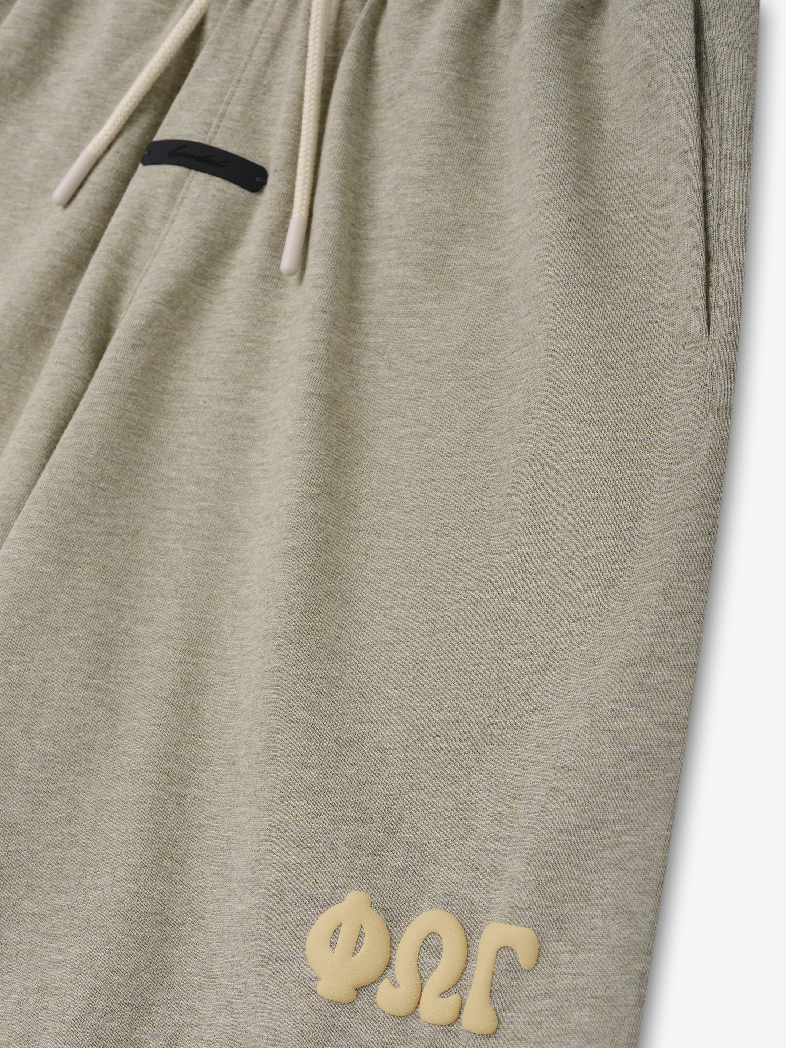 Kids 90'S Jersey Sweatshort in a soft seal heather color with a relaxed fit, adjustable drawstring waistband, side pockets, and raised textured branding near the hem for casual bottoms.