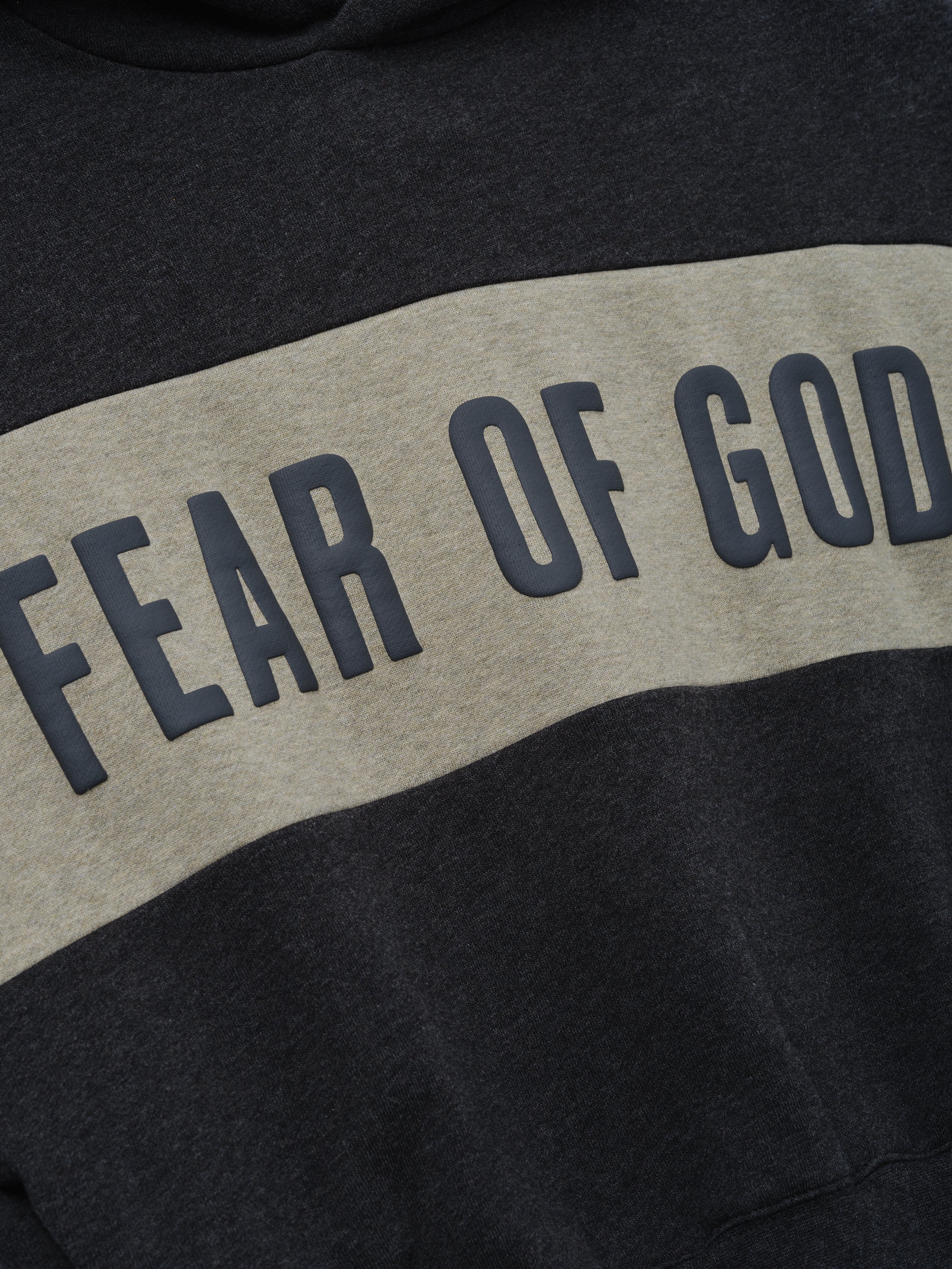 Kids Cropped Relaxed Panelled Hoodie in dark grey with a wide light grey horizontal panel across the chest featuring raised "Fear of God" lettering, designed as stylish kids outerwear.