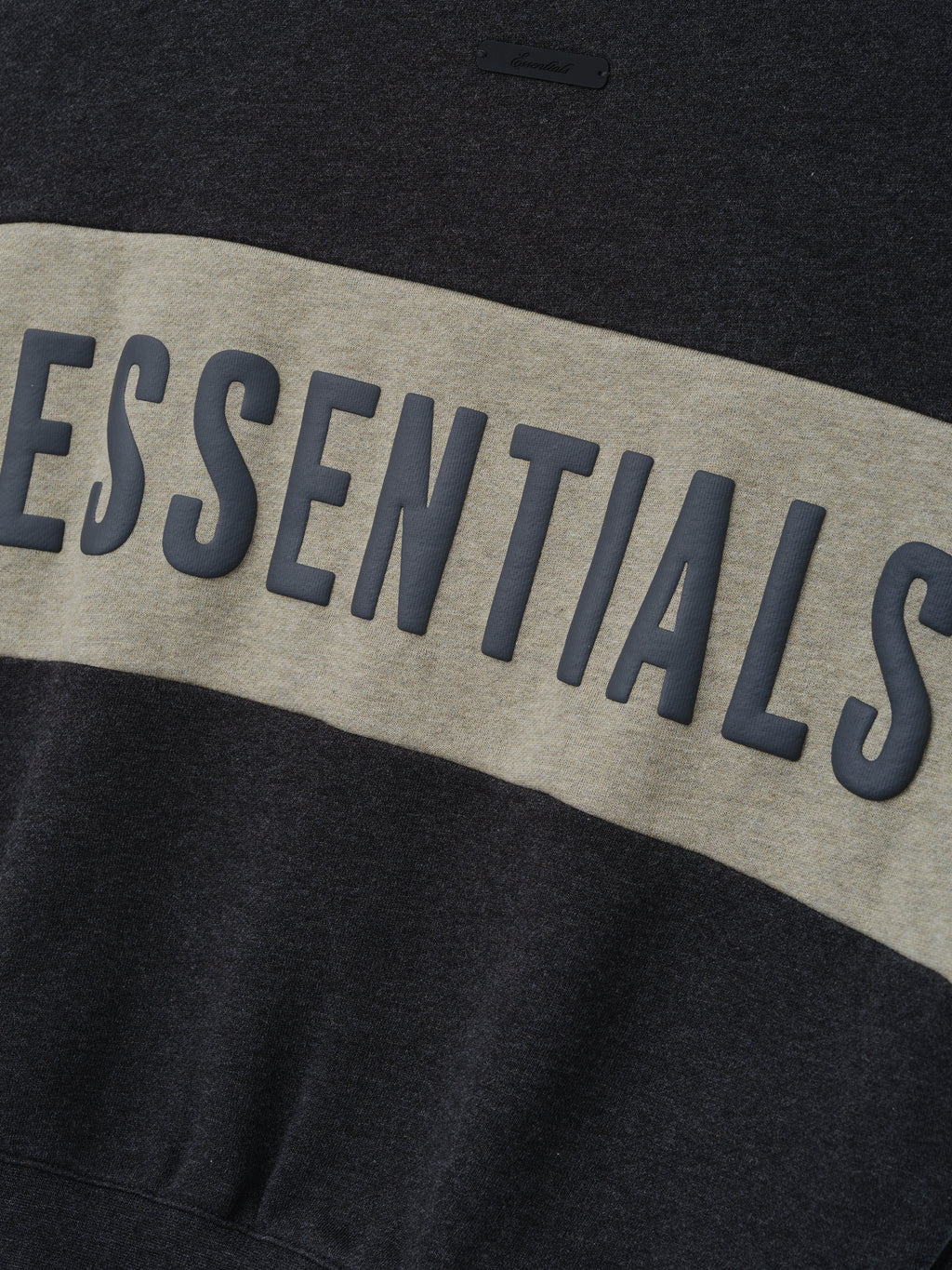 Kids Cropped Relaxed Panelled Sweatshirt in dark grey heather fabric with a wide light grey horizontal panel featuring raised "ESSENTIALS" lettering for stylish kids tops.