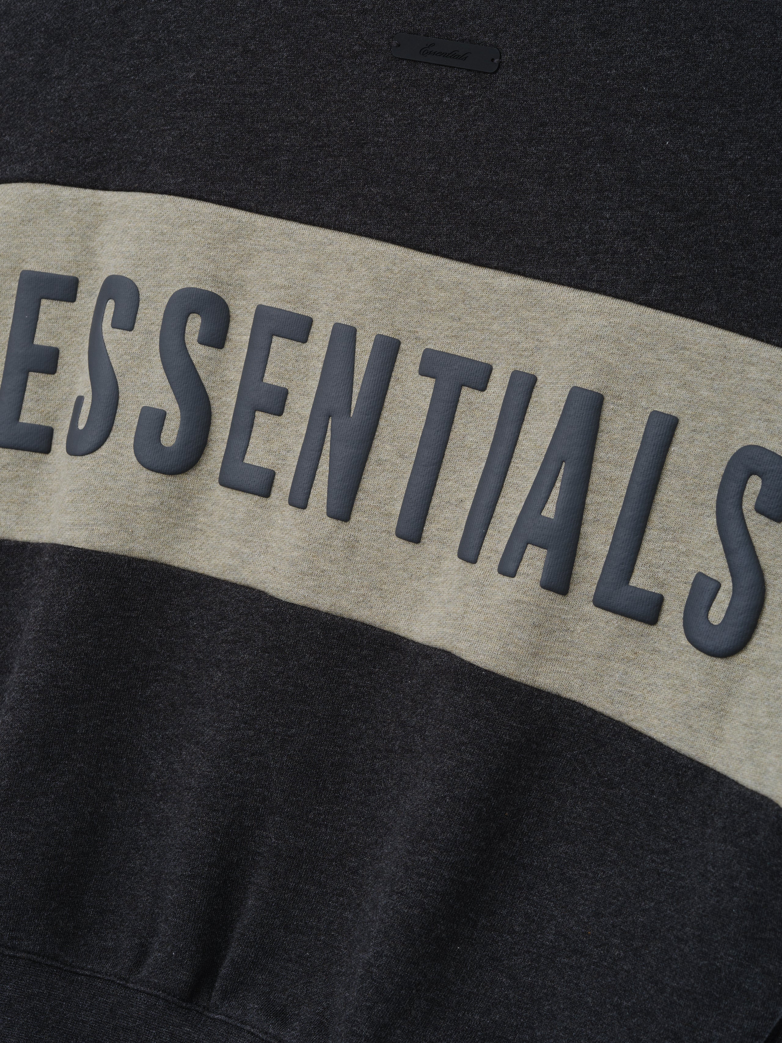Kids Cropped Relaxed Panelled Sweatshirt in dark grey heather fabric with a wide light grey horizontal panel featuring raised "ESSENTIALS" lettering for stylish kids tops.