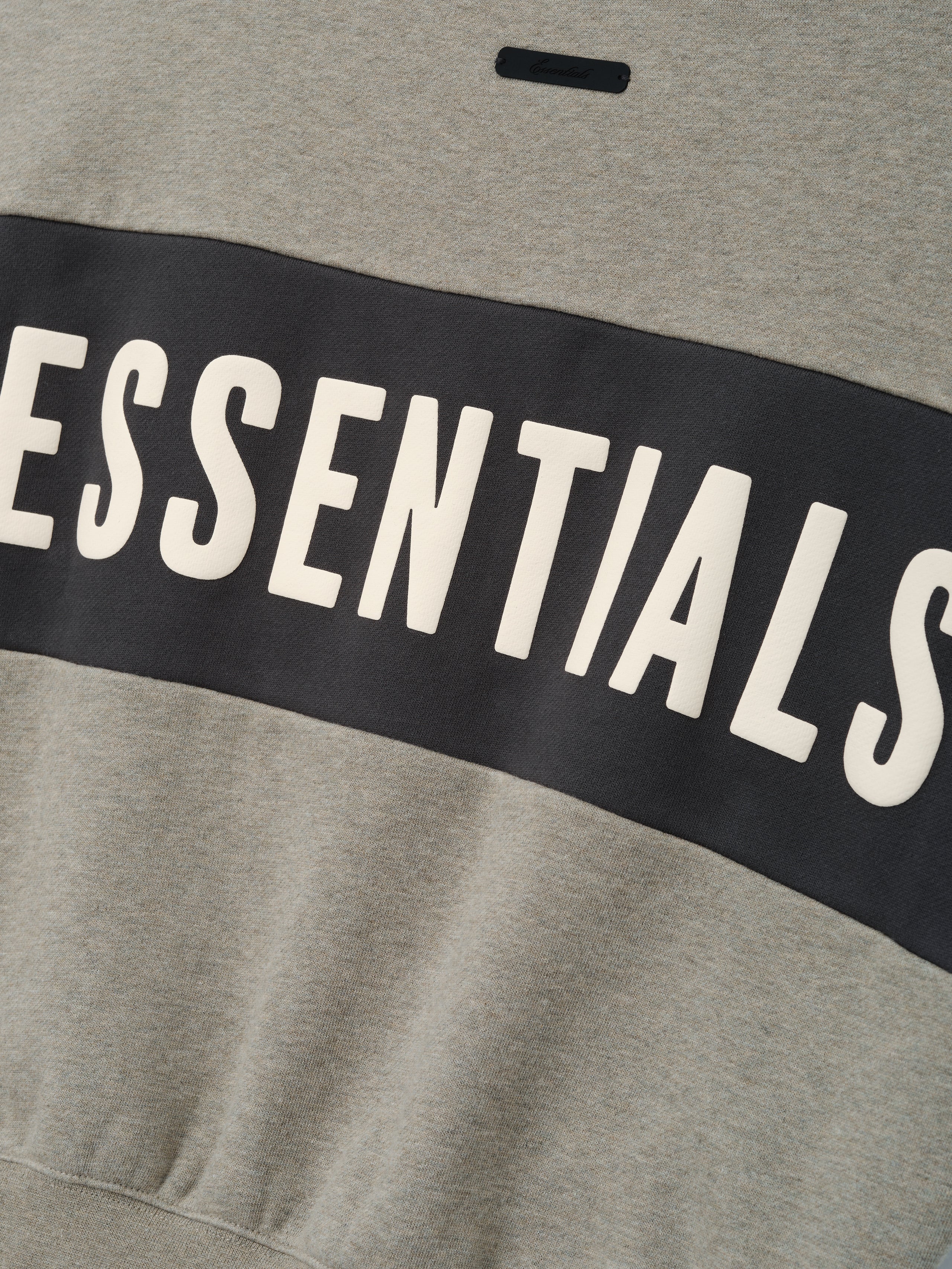 Kids Cropped Relaxed Panelled Sweatshirt in soft seal heather with a wide iron grey panel across the chest featuring bold ESSENTIALS lettering for comfortable kids outerwear.