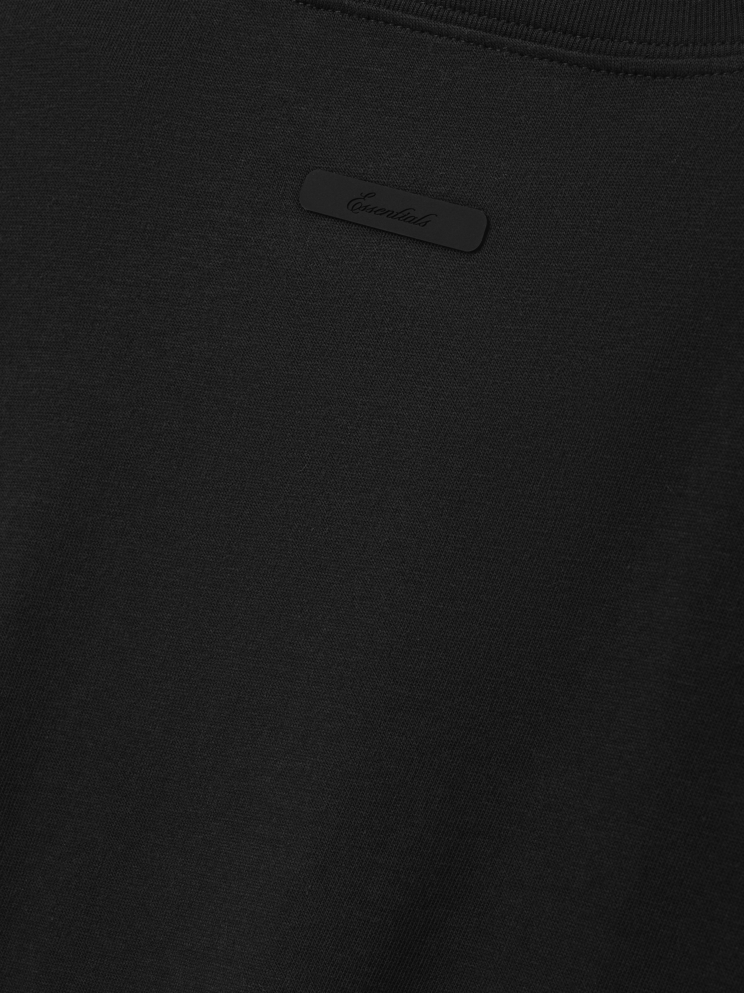Kids Tri-Blend Essential Tee in vintage black featuring a smooth fabric texture with a small tonal label sewn near the neckline for a sleek, subtle branding detail on this kids top.