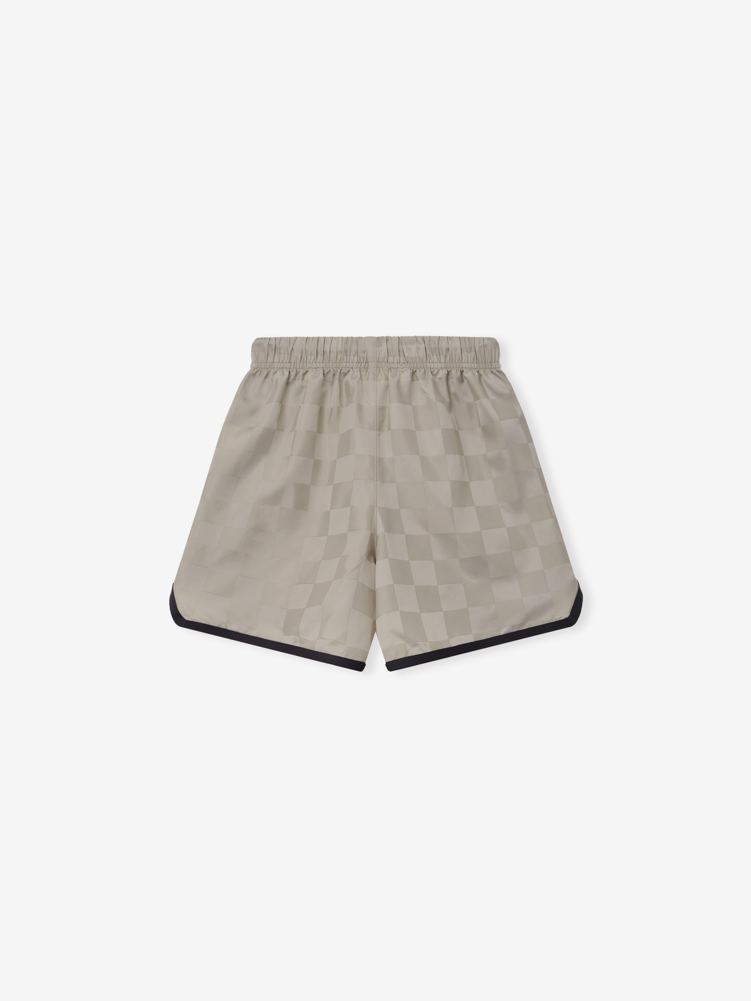 Kids Gym Short in light beige with a subtle checkered pattern, featuring an elastic waistband and black trim along the curved hems for a sporty look.