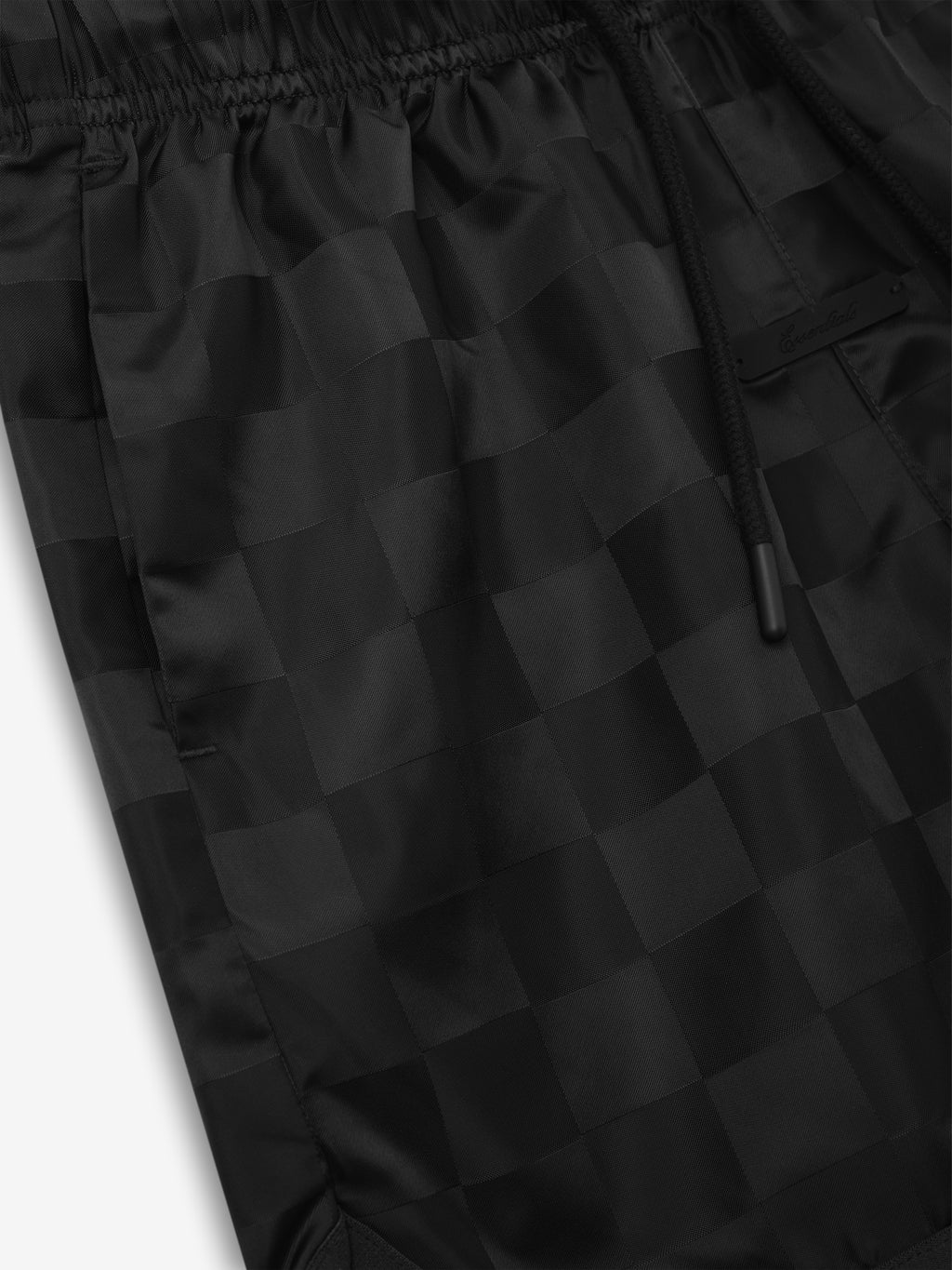Kids Nylon Checkered Gym Short in vintage black, featuring a subtle tonal checkerboard pattern, elastic waistband, and black drawstrings for adjustable comfort in activewear bottoms.