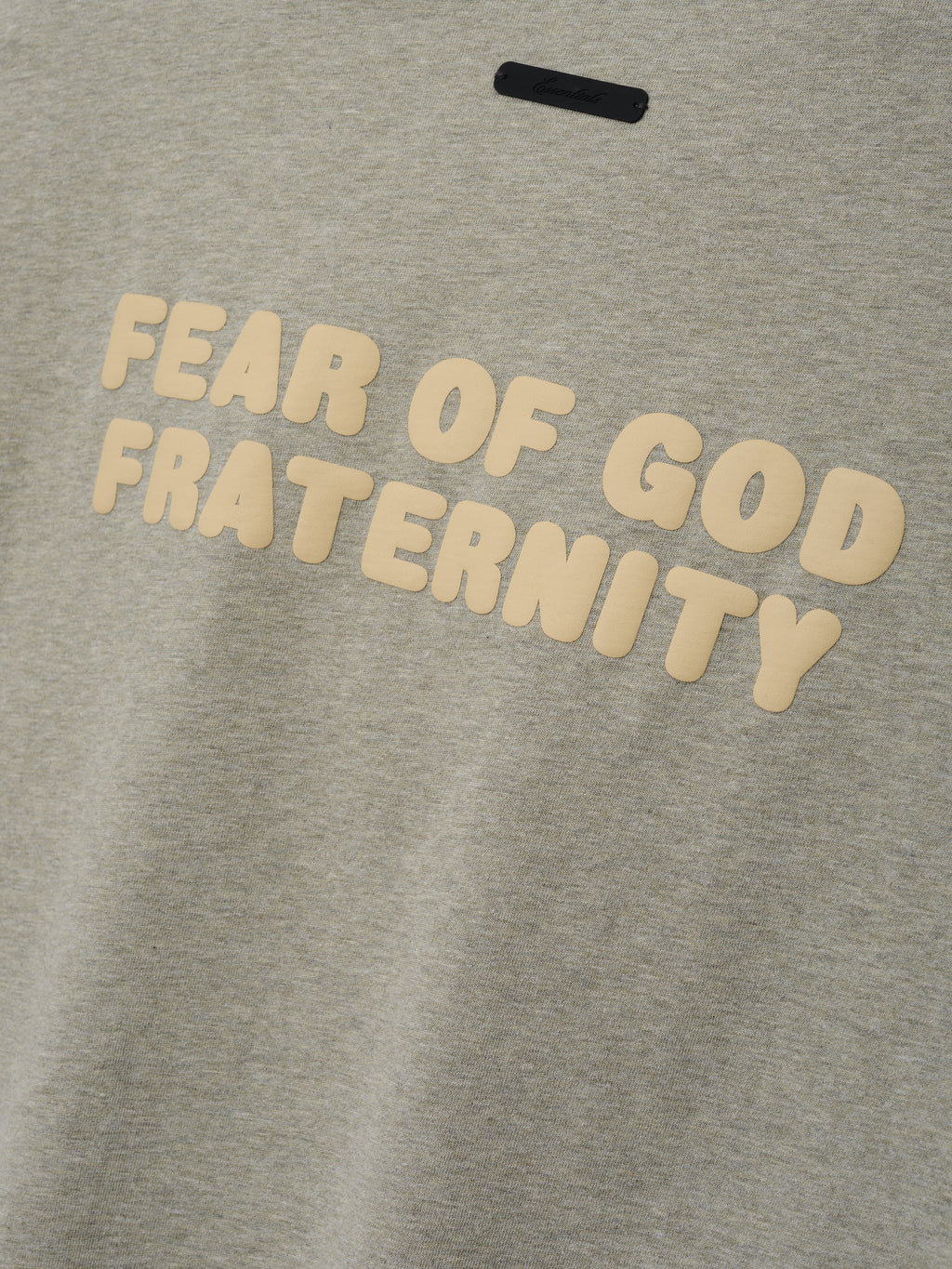 Kids Merch Long Sleeve Tee in light gray heather fabric featuring raised cream lettering spelling "Fear of God Fraternity" on the front for a soft, casual look.