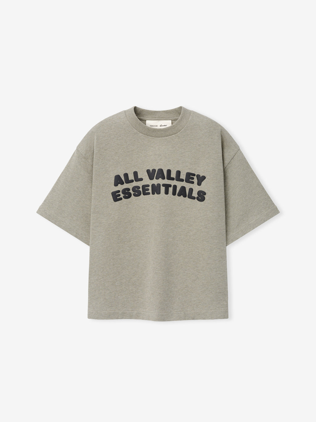 Kids Merch Tee in soft muted gray fabric featuring bold black rounded text "ALL VALLEY ESSENTIALS" in a curved layout for a casual, comfortable kids' top.