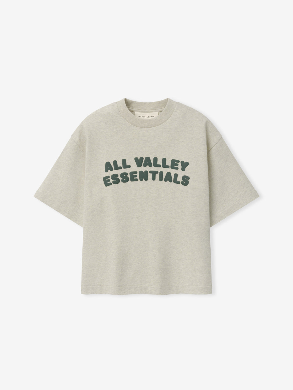 Kids Merch Tee in light vanilla heather fabric featuring dark green rounded text "ALL VALLEY ESSENTIALS" in a relaxed, casual style for a comfortable kids' top.