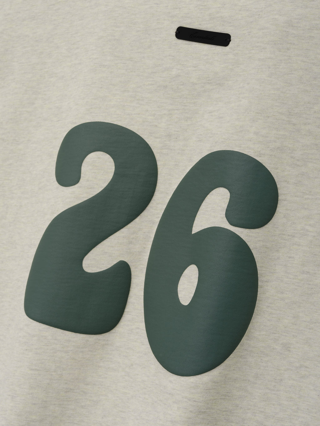 Kids Merch Tee in light vanilla heather fabric featuring a large dark green number "26" in a bold, rounded style for a trendy and comfortable kids' top.