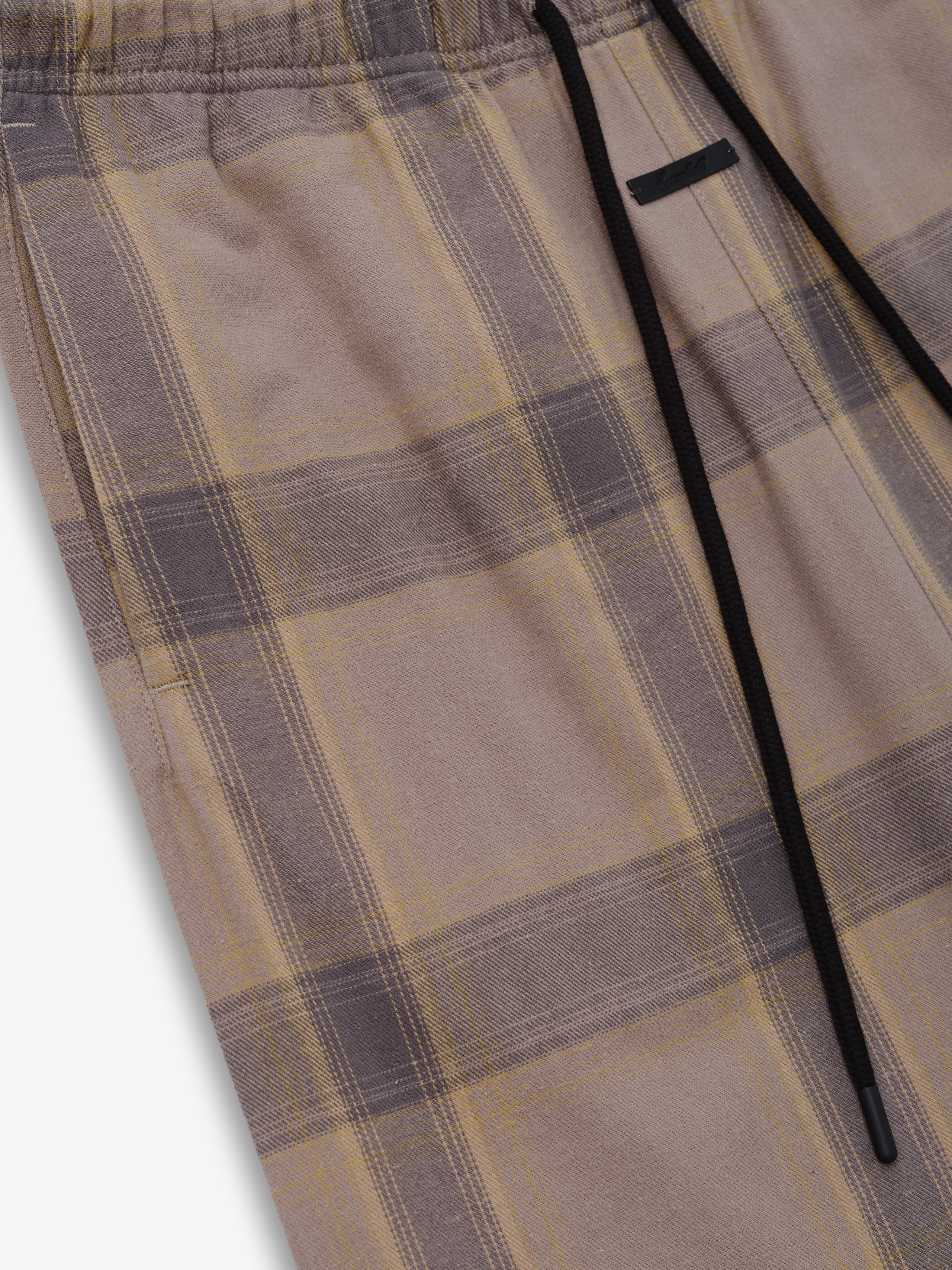 Womens Flannel Lounge Pant in a soft plaid pattern with muted beige and gray tones, featuring an elastic waistband and black drawstrings for a cozy, relaxed fit.