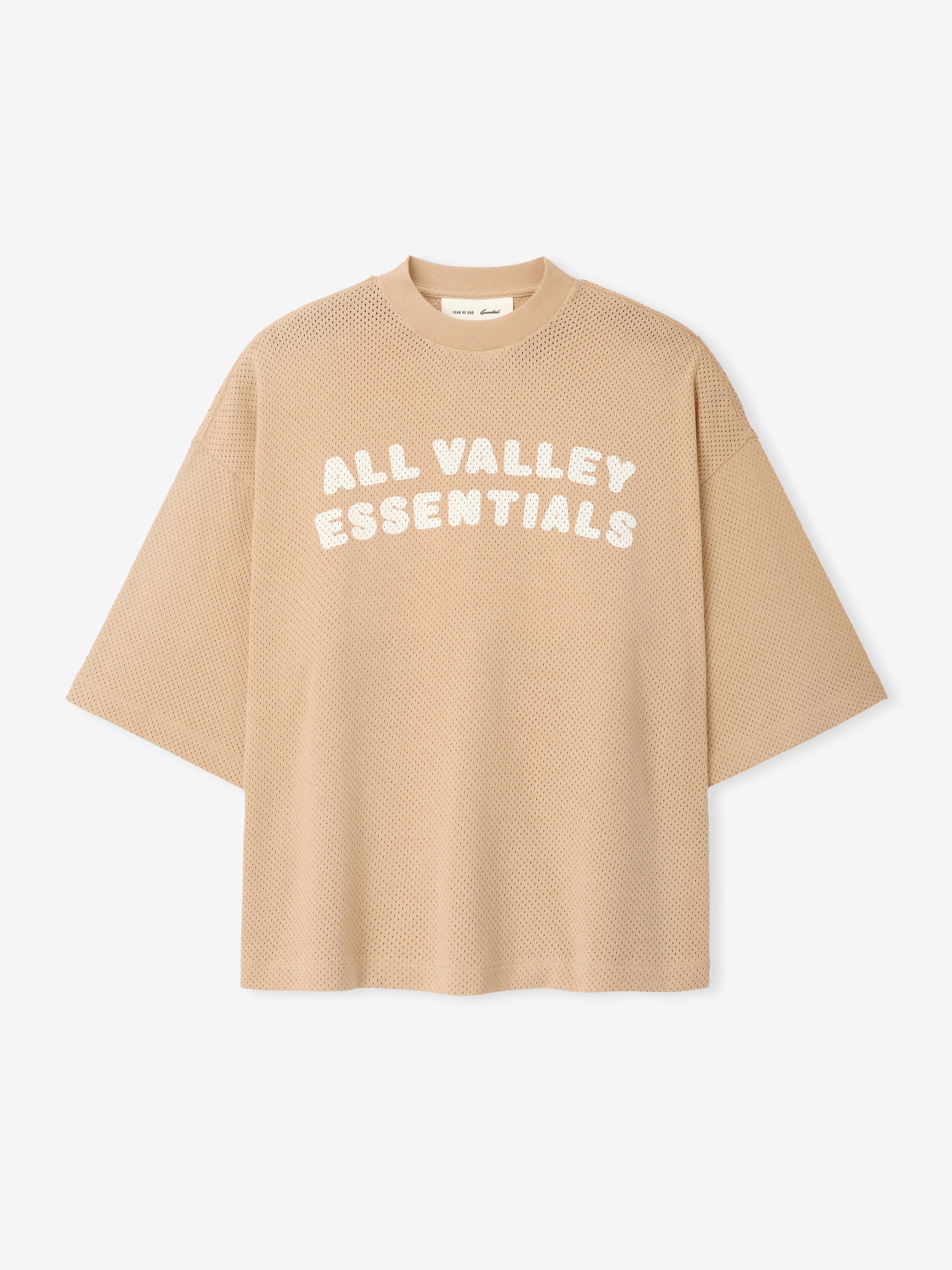 Womens Sport Mesh Merch Tee in soft beige featuring textured breathable mesh fabric and bold white "ALL VALLEY ESSENTIALS" text across the front for a modern athletic top.