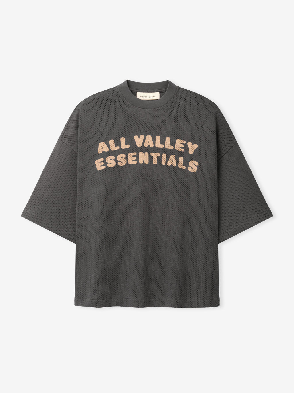 Womens Sport Mesh Merch Tee in dark iron grey featuring breathable textured fabric with relaxed fit and soft peach "ALL VALLEY ESSENTIALS" text across the chest for a casual sporty top.