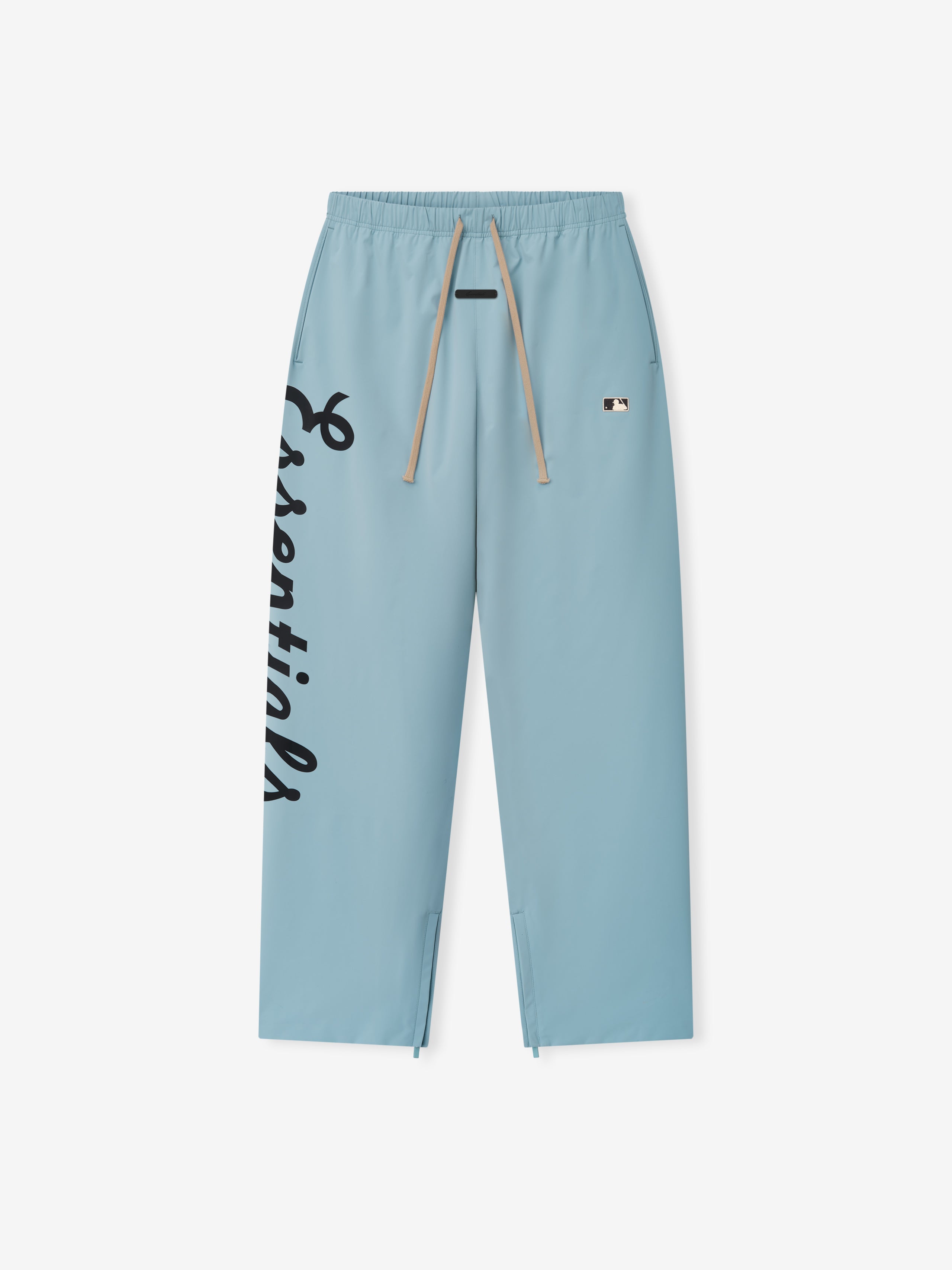 Light blue Mlb Relaxed Track Pant featuring black script lettering down the left leg, beige drawstrings at the elastic waistband, and a small contrasting logo patch near the pocket, designed as stylish casual bottoms.