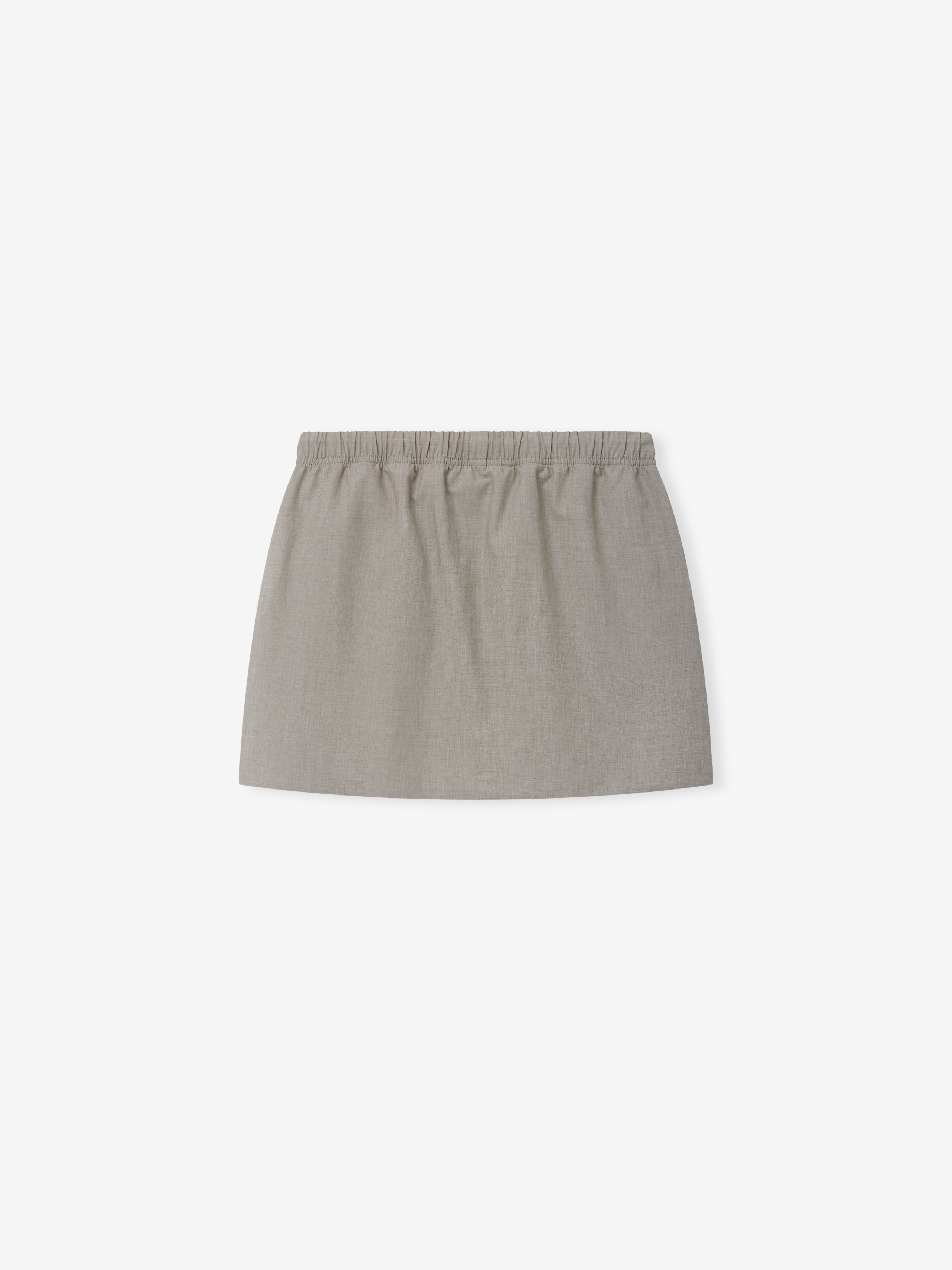 Micro Skirt in a soft neutral tone featuring a smooth fabric with an elastic waistband for a comfortable and versatile modern bottom.