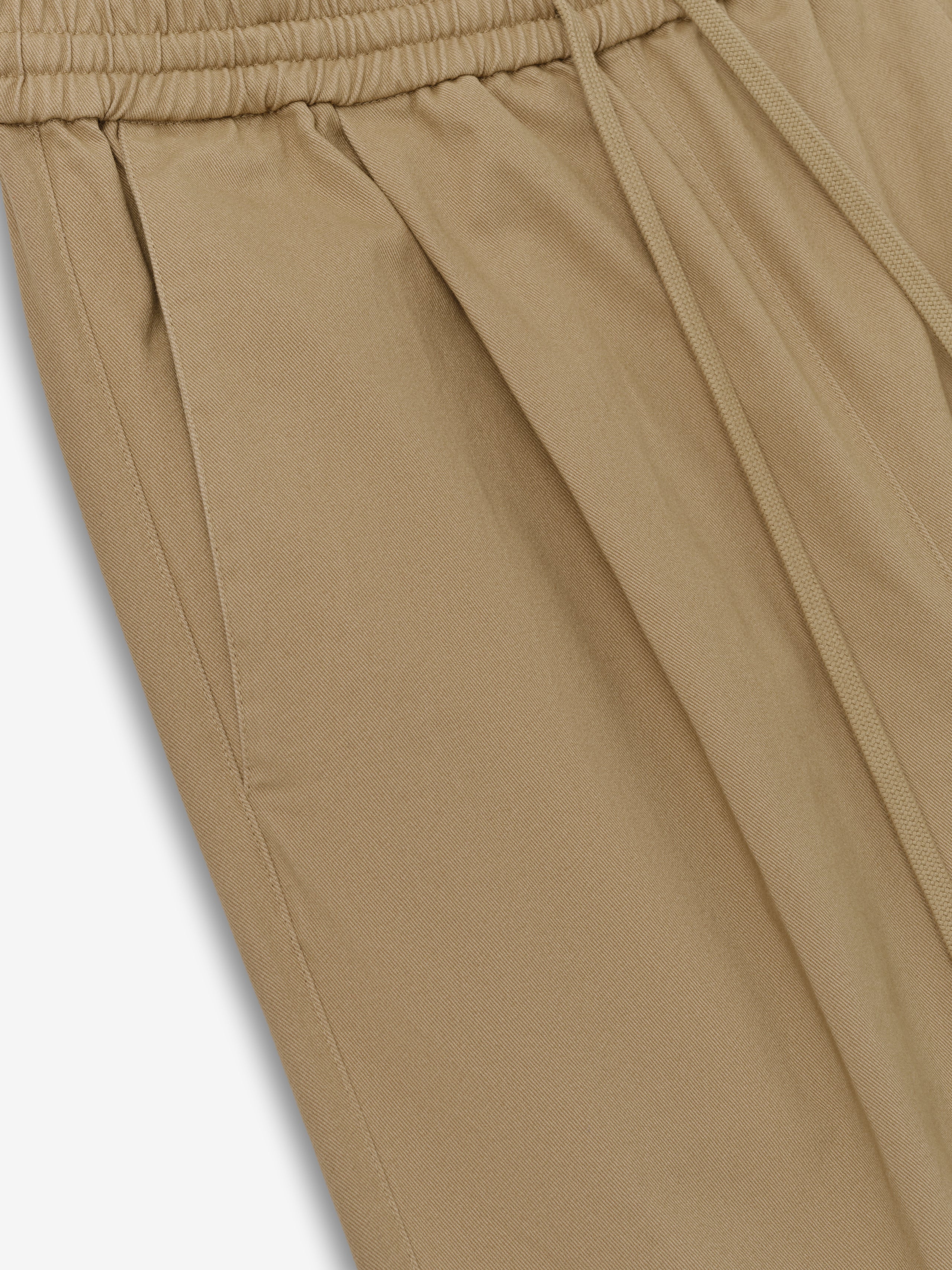 Womens Cotton Twill Pleat Front Drawstring Pant in a warm beige tone, featuring side pockets, front pleating, and an elastic waistband with adjustable drawstring for comfortable casual bottoms.