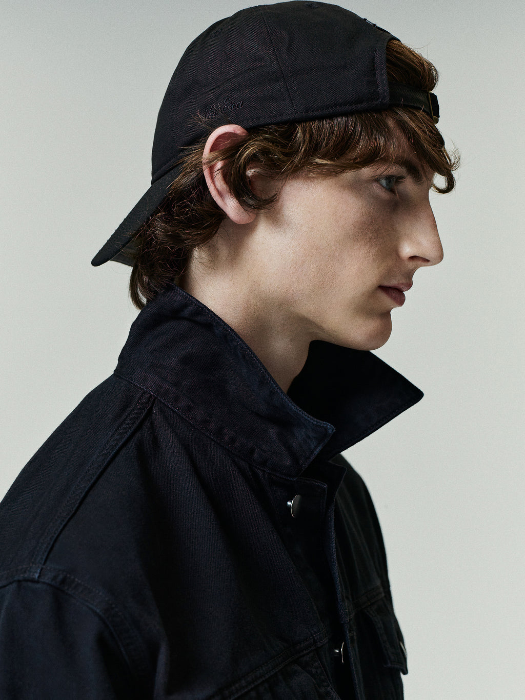 Classic Denim Jacket in a dark overdyed black shade featuring a structured collar, sturdy denim fabric, and clean stitching for a timeless outerwear style.