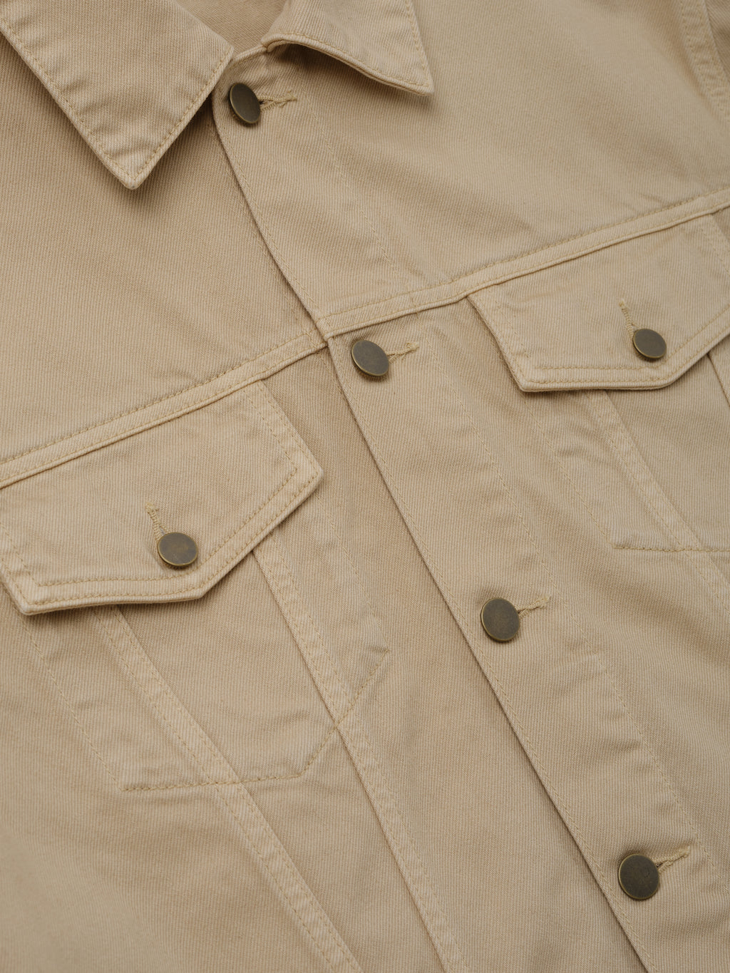 Classic Denim Jacket in a muted dune color featuring a pointed collar, metal snap buttons, flap chest pockets, and durable cotton fabric for stylish outerwear layering.