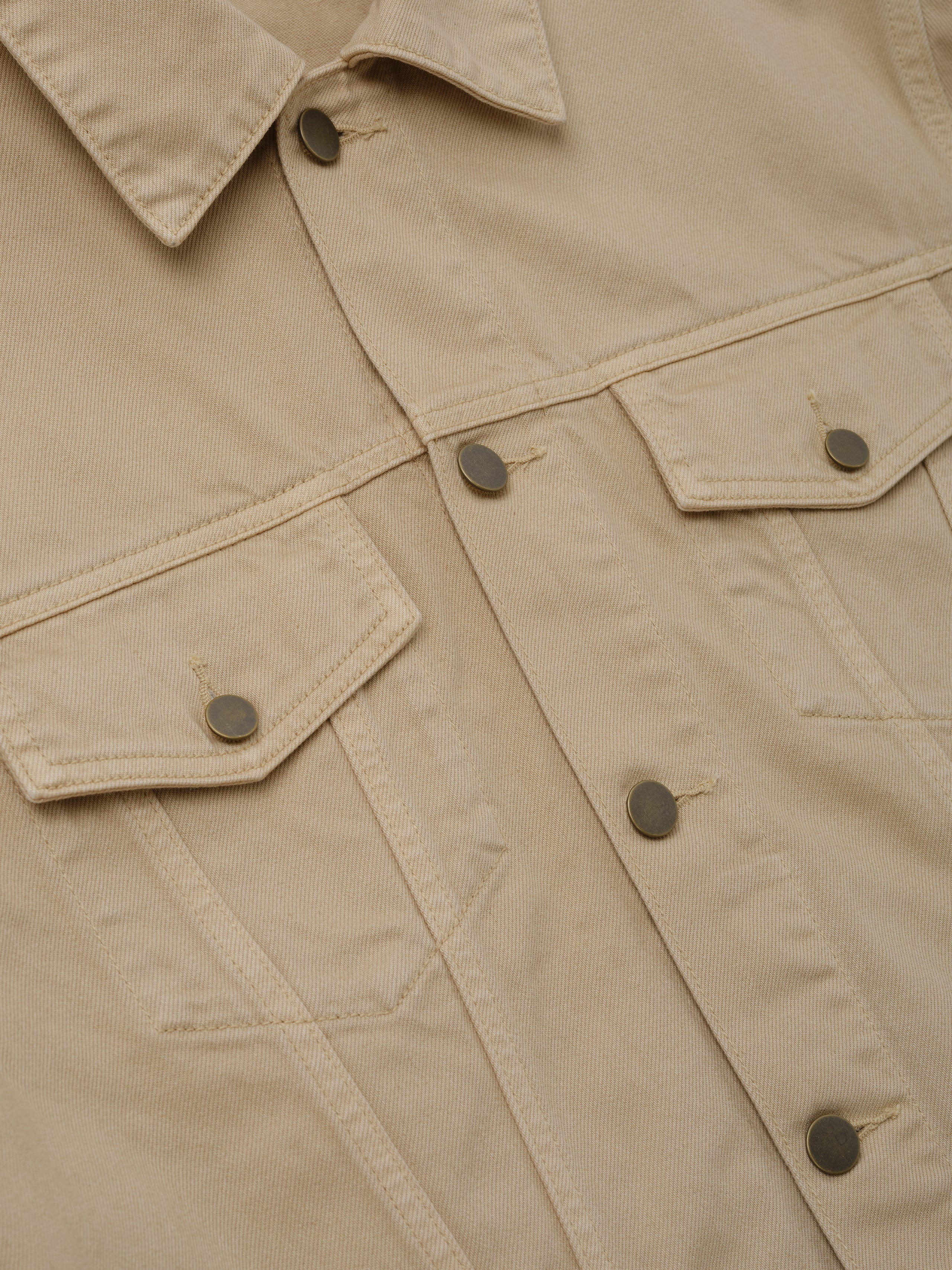 Classic Denim Jacket in a muted dune color featuring a pointed collar, metal snap buttons, flap chest pockets, and durable cotton fabric for stylish outerwear layering.