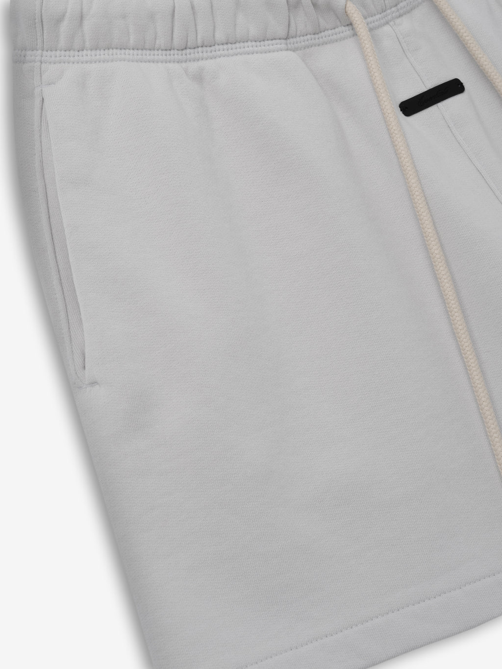 Womens Classic Fit Short in a soft light grey shade featuring an elastic waistband with natural drawstrings, side pockets, and a relaxed fit for comfortable casual bottoms.