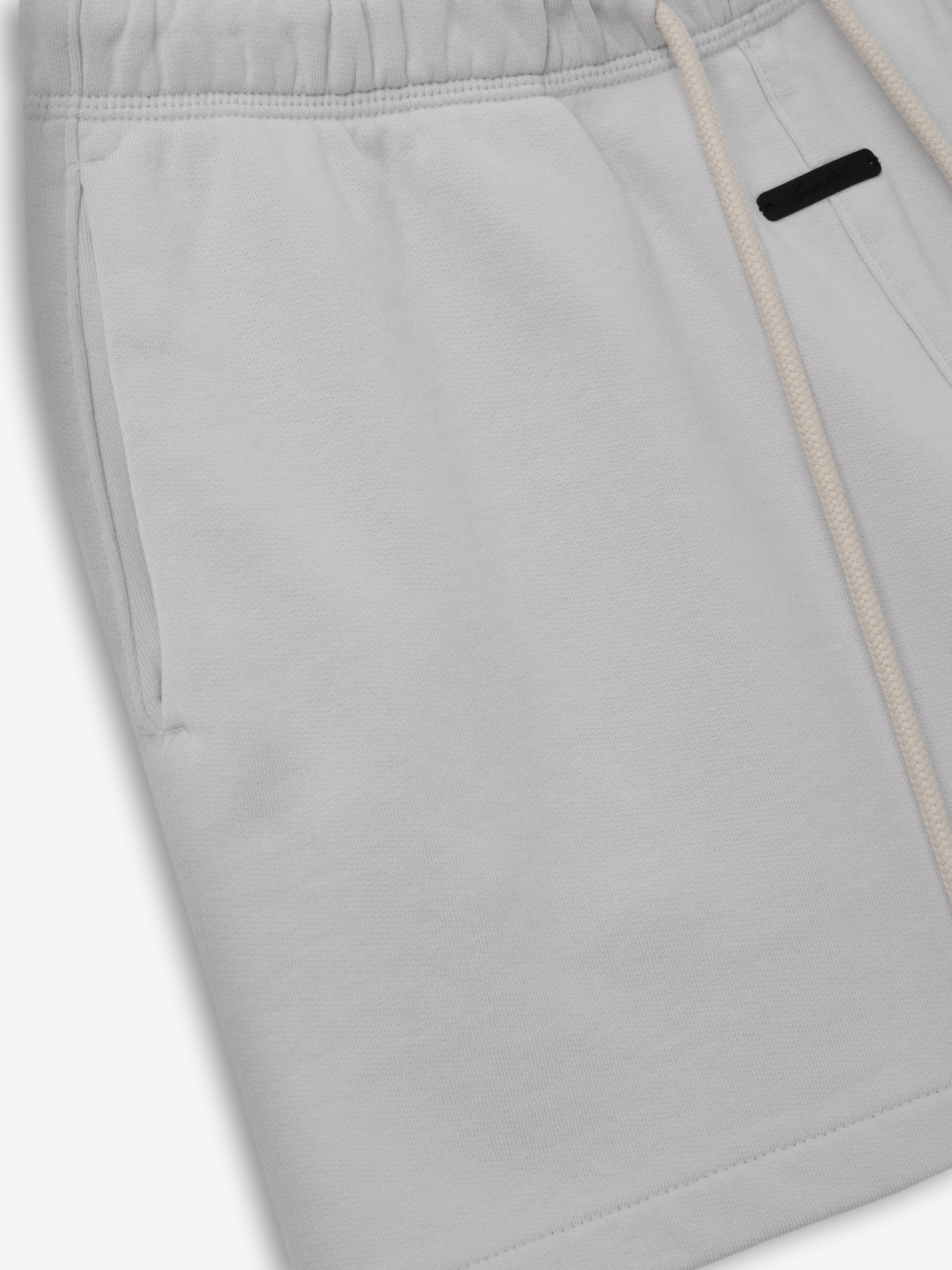 Womens Classic Fit Short in a soft light grey shade featuring an elastic waistband with natural drawstrings, side pockets, and a relaxed fit for comfortable casual bottoms.