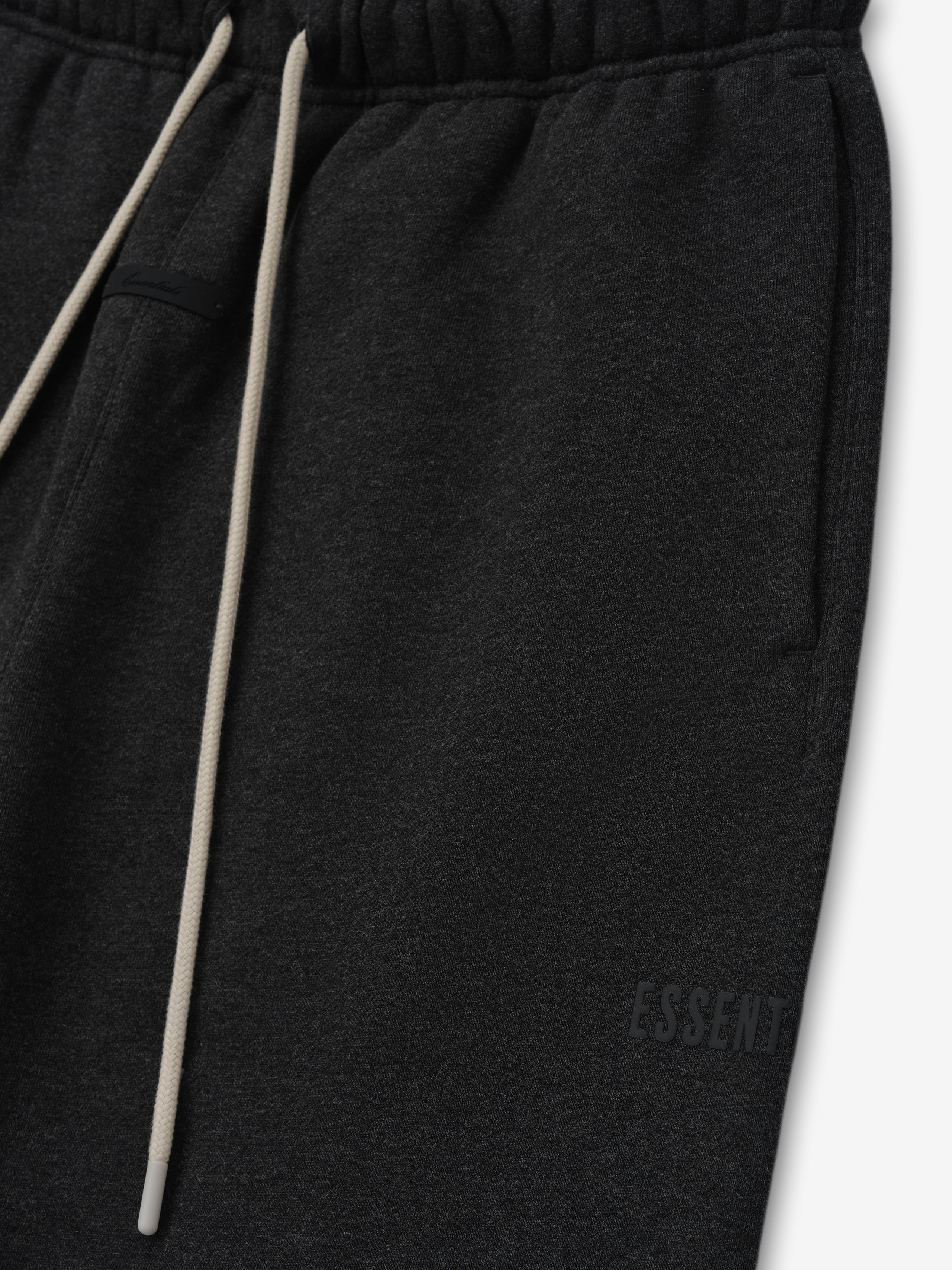 Classic Fleece Sweatpant in dark grey heather with an elastic waistband, long beige drawstrings, side pockets, and subtle tonal branding for a minimalist casual look.