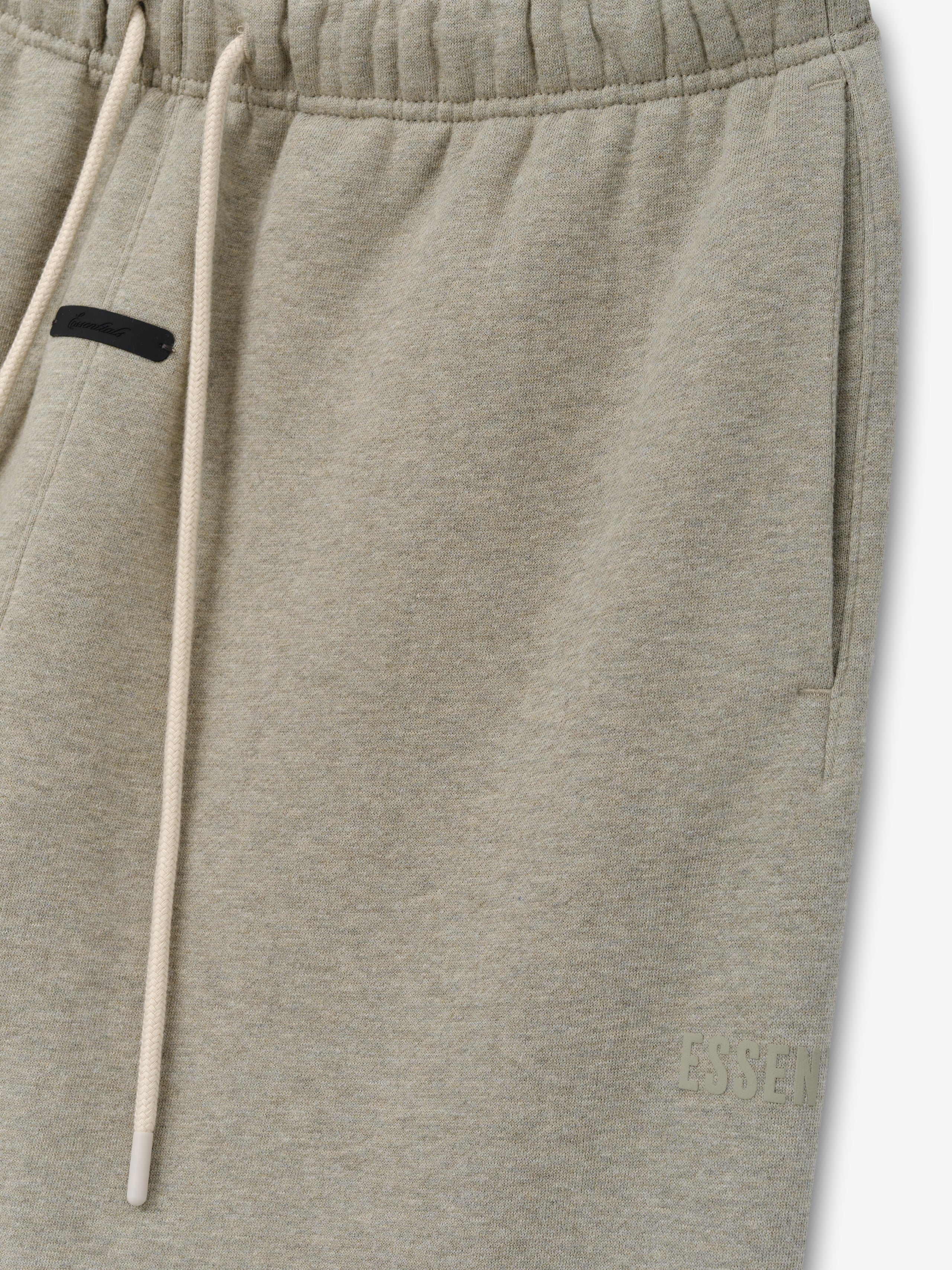 Classic Fleece Sweatpant in a muted beige heather shade featuring an elastic waistband with long drawstrings, side pockets, and a subtle tonal logo for comfortable casual bottoms.