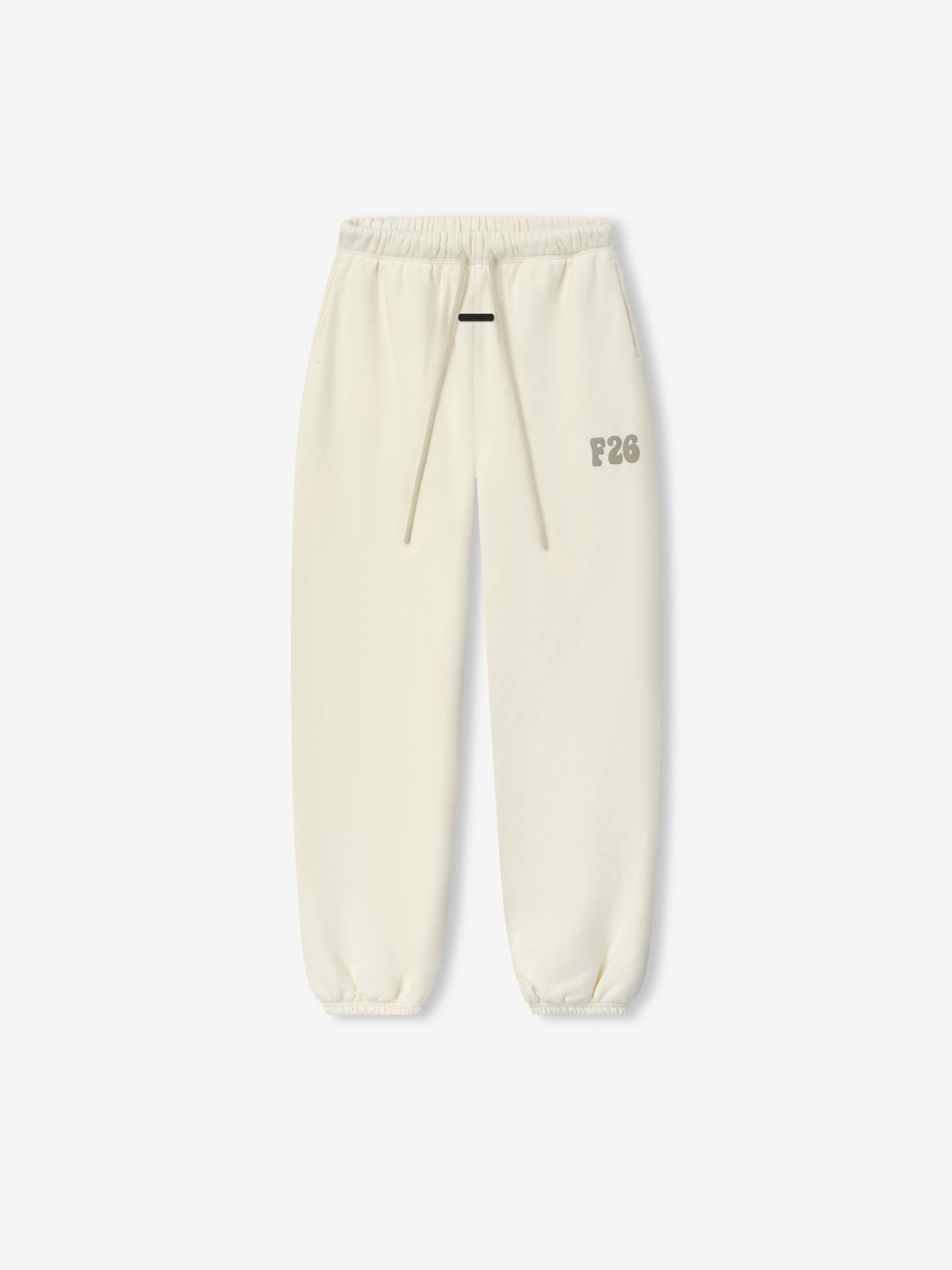 Womens Classic Fleece Sweatpant in a soft washed ivory tone with an elastic waistband, matching drawstrings, elastic cuffs, and a subtle F26 logo on the thigh for cozy casual bottoms.