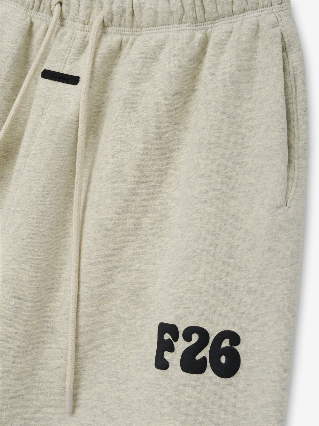 Womens Classic Fleece Sweatpant in a soft washed vanilla hue featuring an elastic waistband with drawstring, side pockets, and a prominent black F26 logo on the thigh for casual comfort.