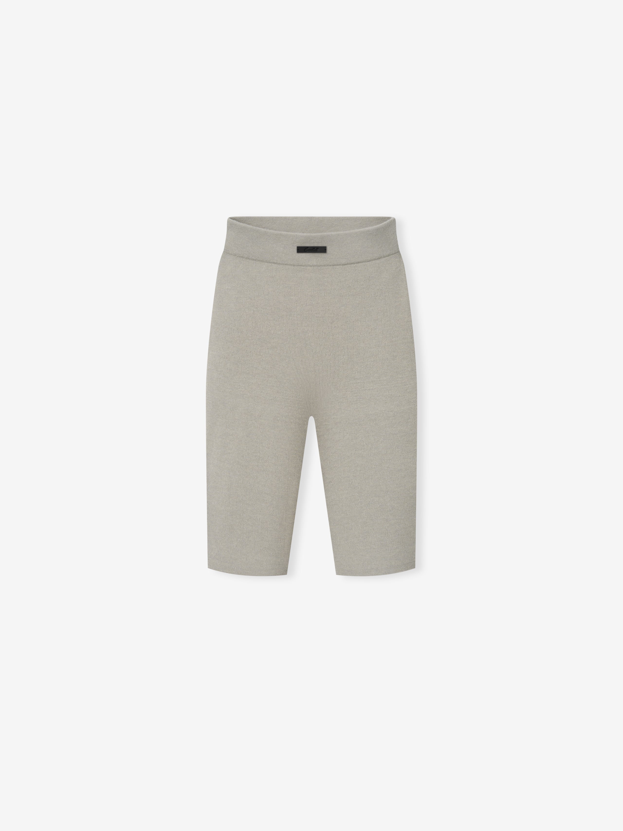 Womens Rib Knit Biker Short in a soft light grey ribbed fabric, featuring a high waistband and knee-length cut for a sleek, comfortable casual bottom.