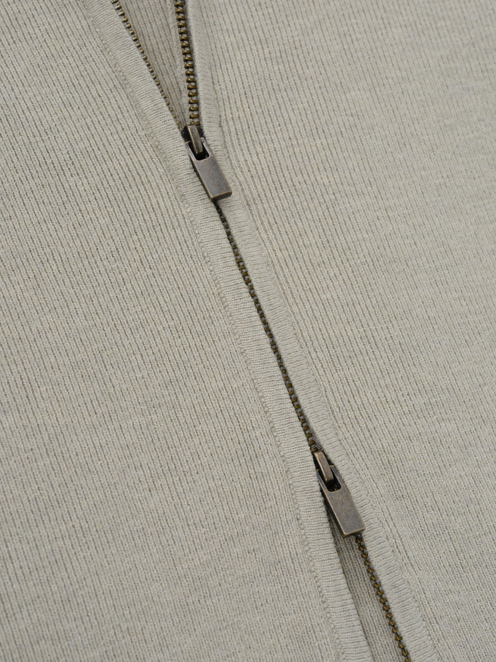 Womens Rib Knit Zip Up Jacket in a soft neutral tone, showcasing a finely ribbed fabric with a double zipper detail for versatile and modern outerwear styling.