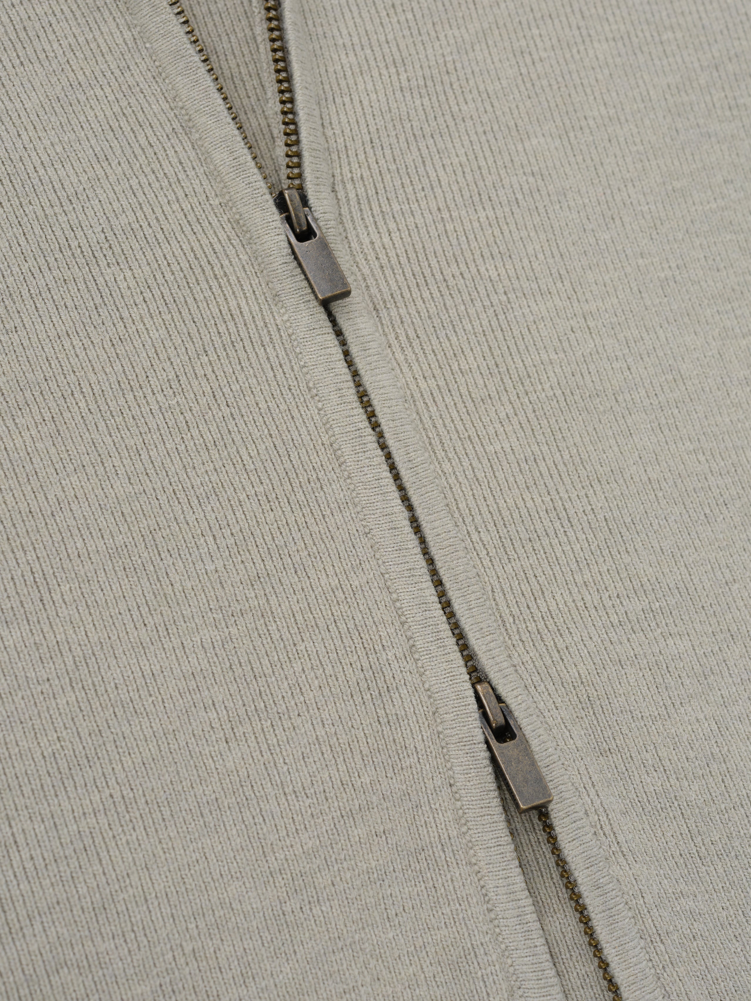 Womens Rib Knit Zip Up Jacket in a soft neutral tone, showcasing a finely ribbed fabric with a double zipper detail for versatile and modern outerwear styling.