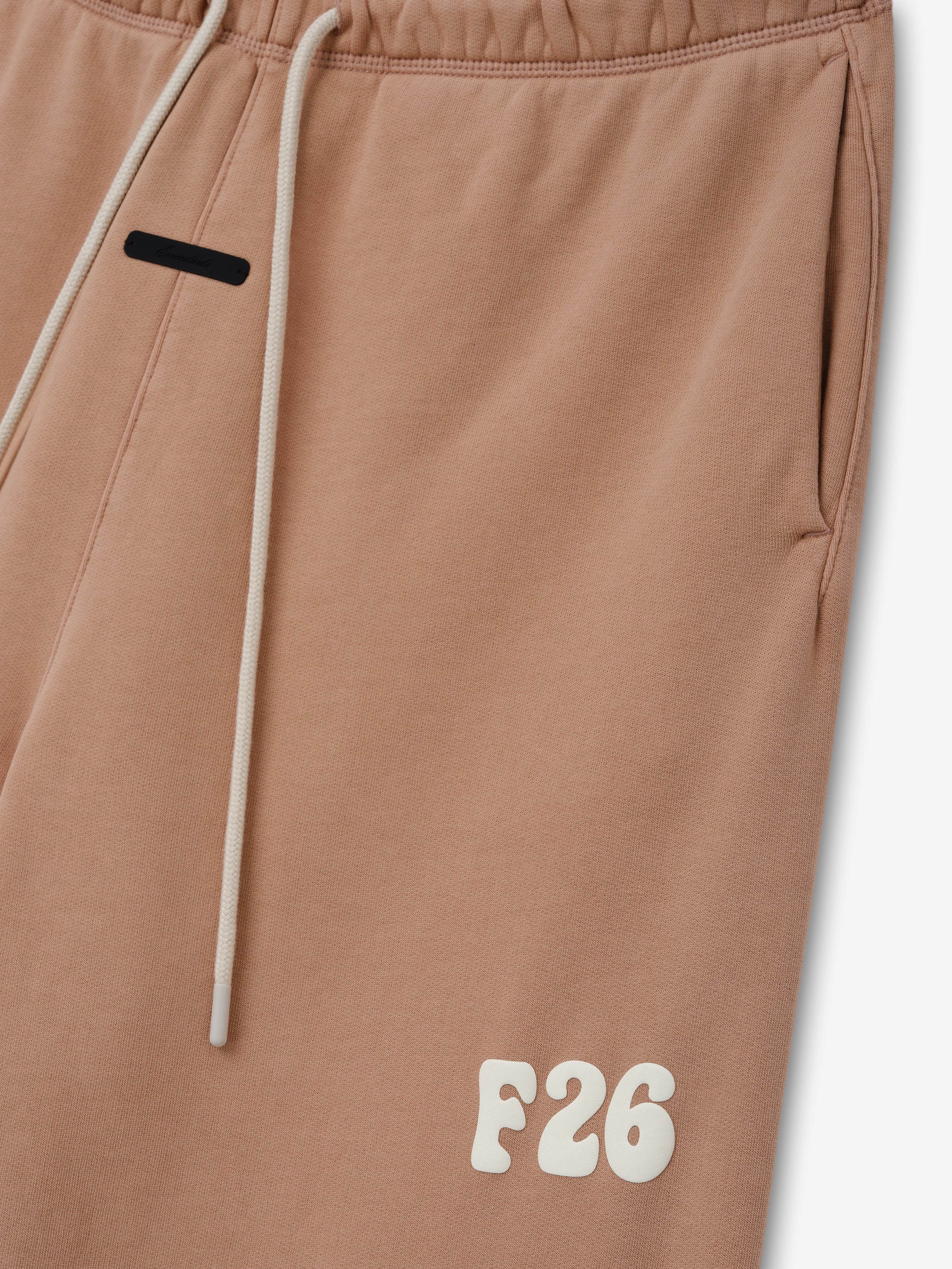 Classic Fleece Sweatpant in a washed ginger shade featuring an elastic waistband with cream drawstrings, side pockets, and a raised F26 logo near the hem for relaxed casual bottoms.