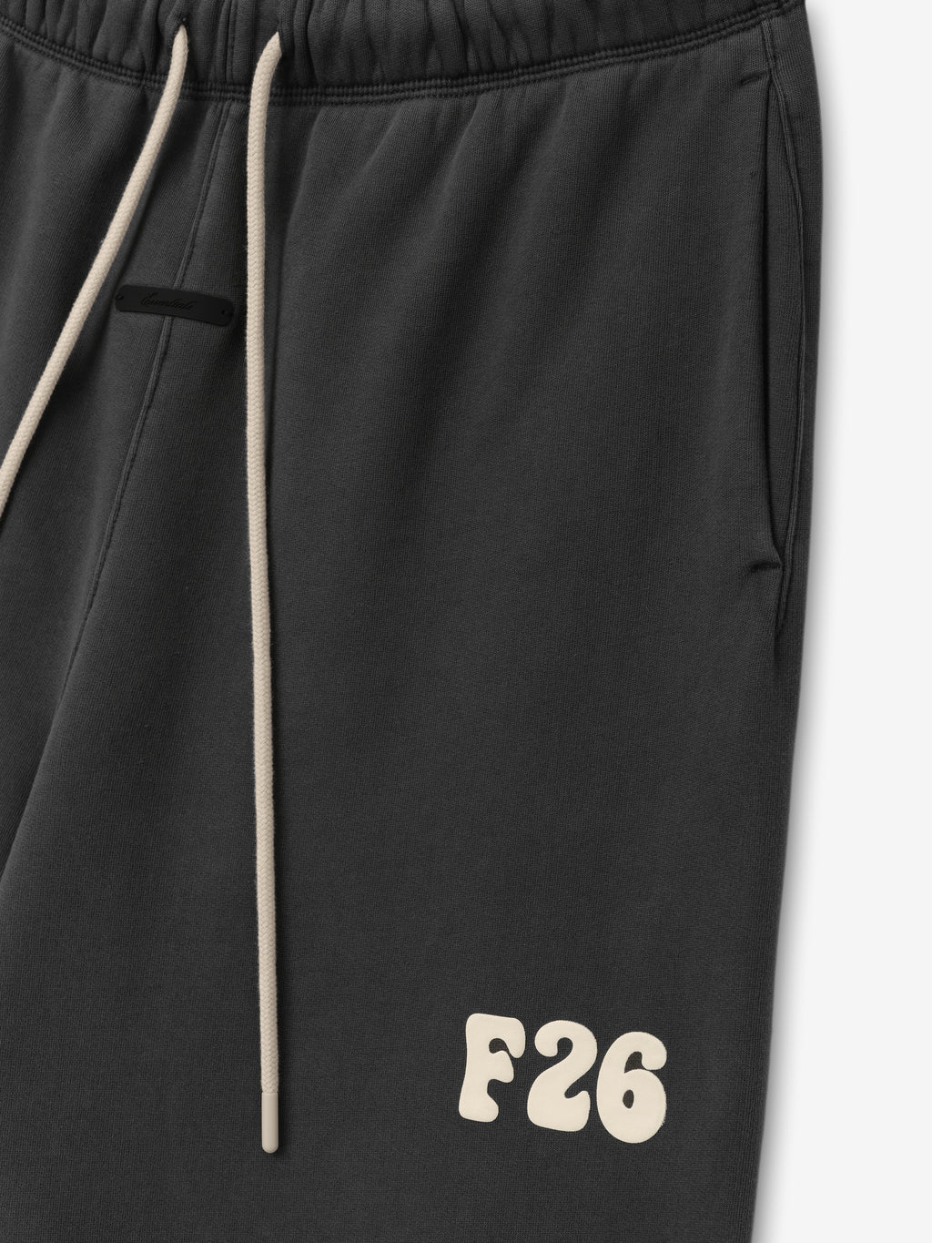Classic Fleece Sweatpant in a deep washed iron grey shade featuring an elastic waistband with contrasting light drawstrings, side pockets, and a cream F26 logo on the thigh for casual bottoms.