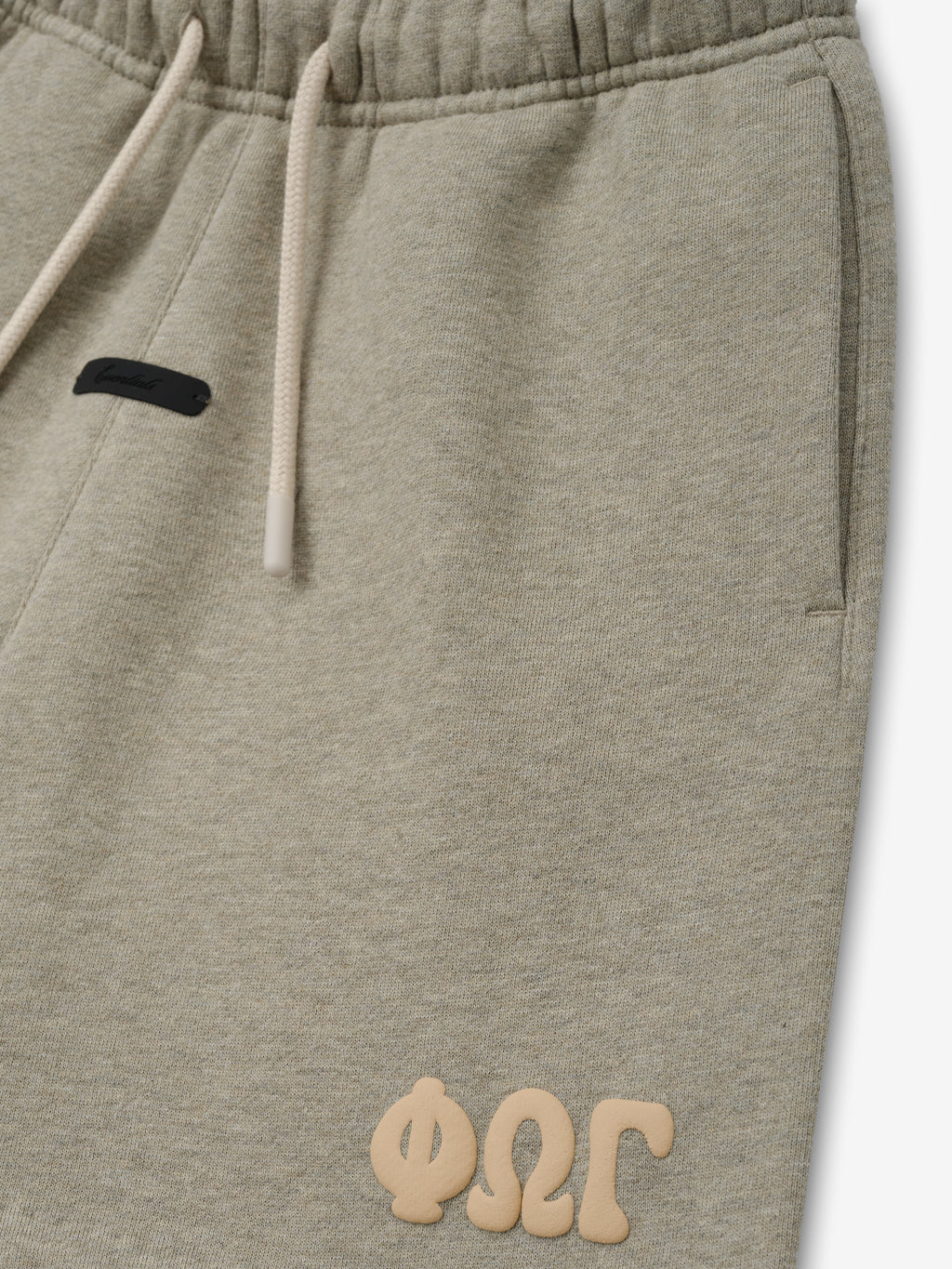 Kids Classic Sweatshort in a soft muted beige shade, featuring an elastic waistband with light drawstrings, side pockets, and a raised logo detail for relaxed kids bottoms.