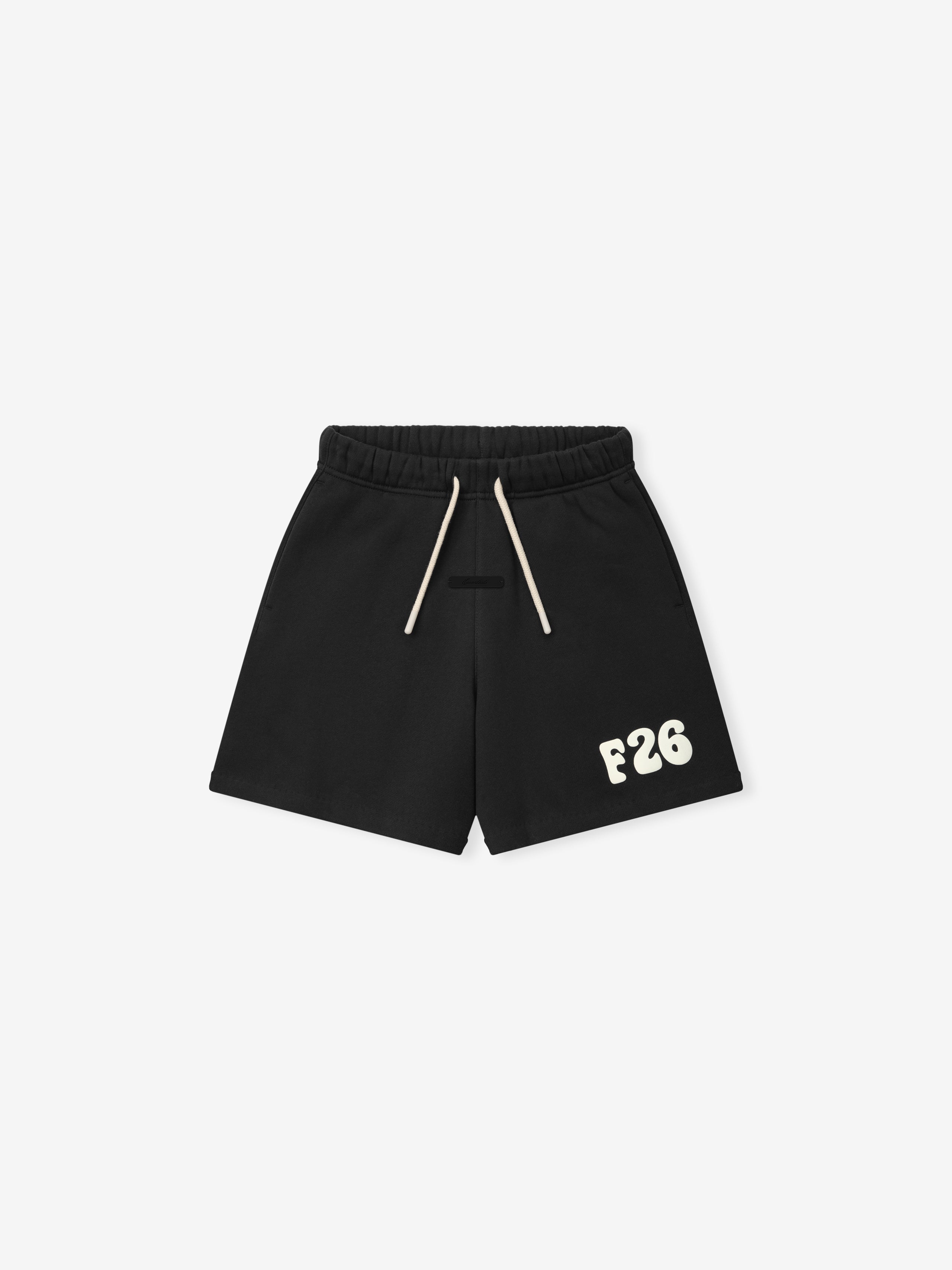 Kids Classic Sweatshort in a vintage black shade, featuring a soft elastic waistband with contrasting cream drawstrings and bold cream "F26" printed detail for casual kids bottoms.