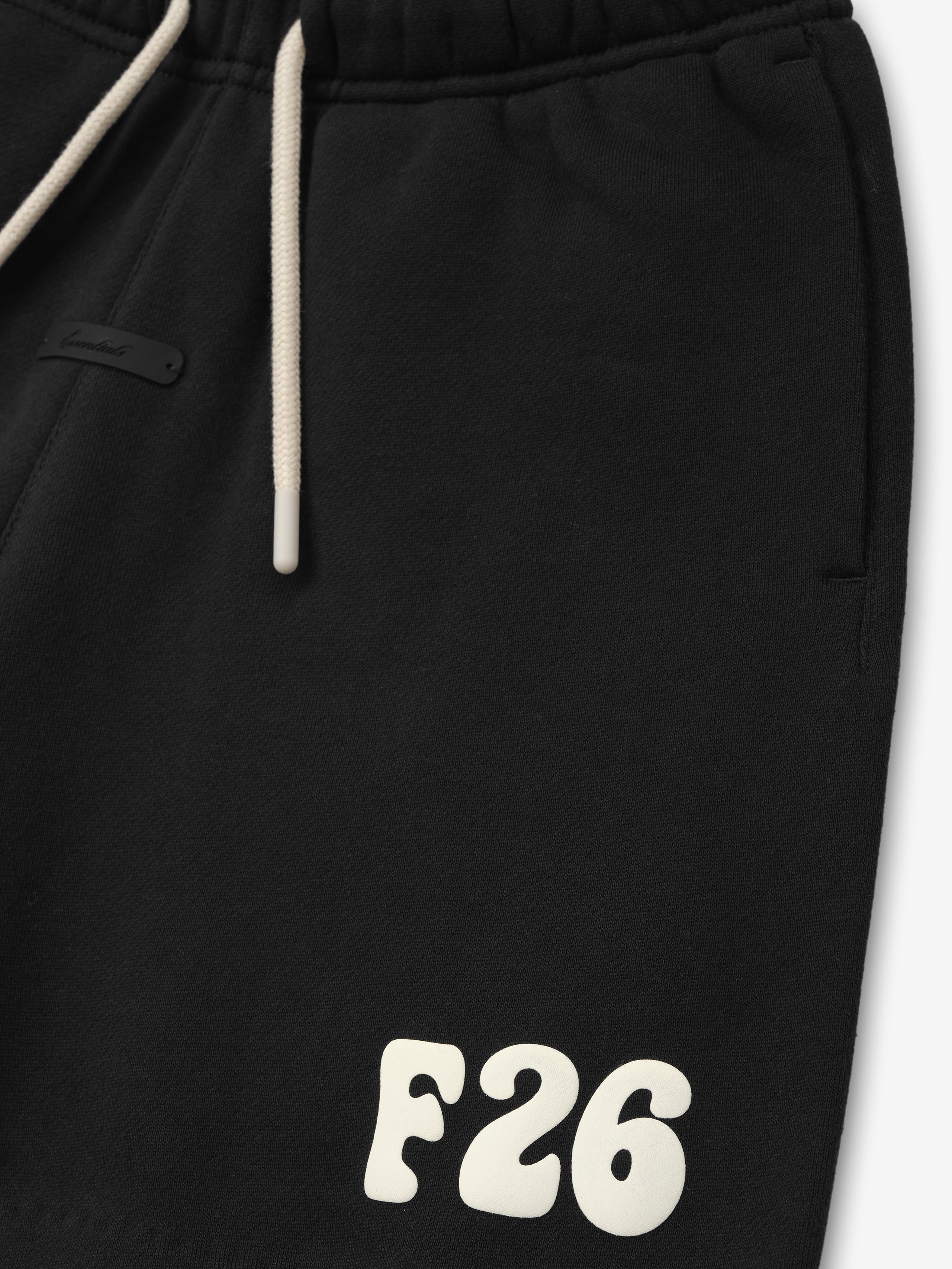 Kids Classic Sweatshort in a vintage black hue, featuring a soft elastic waistband with contrasting cream drawstrings and a bold cream "F26" logo detail for casual kids bottoms.