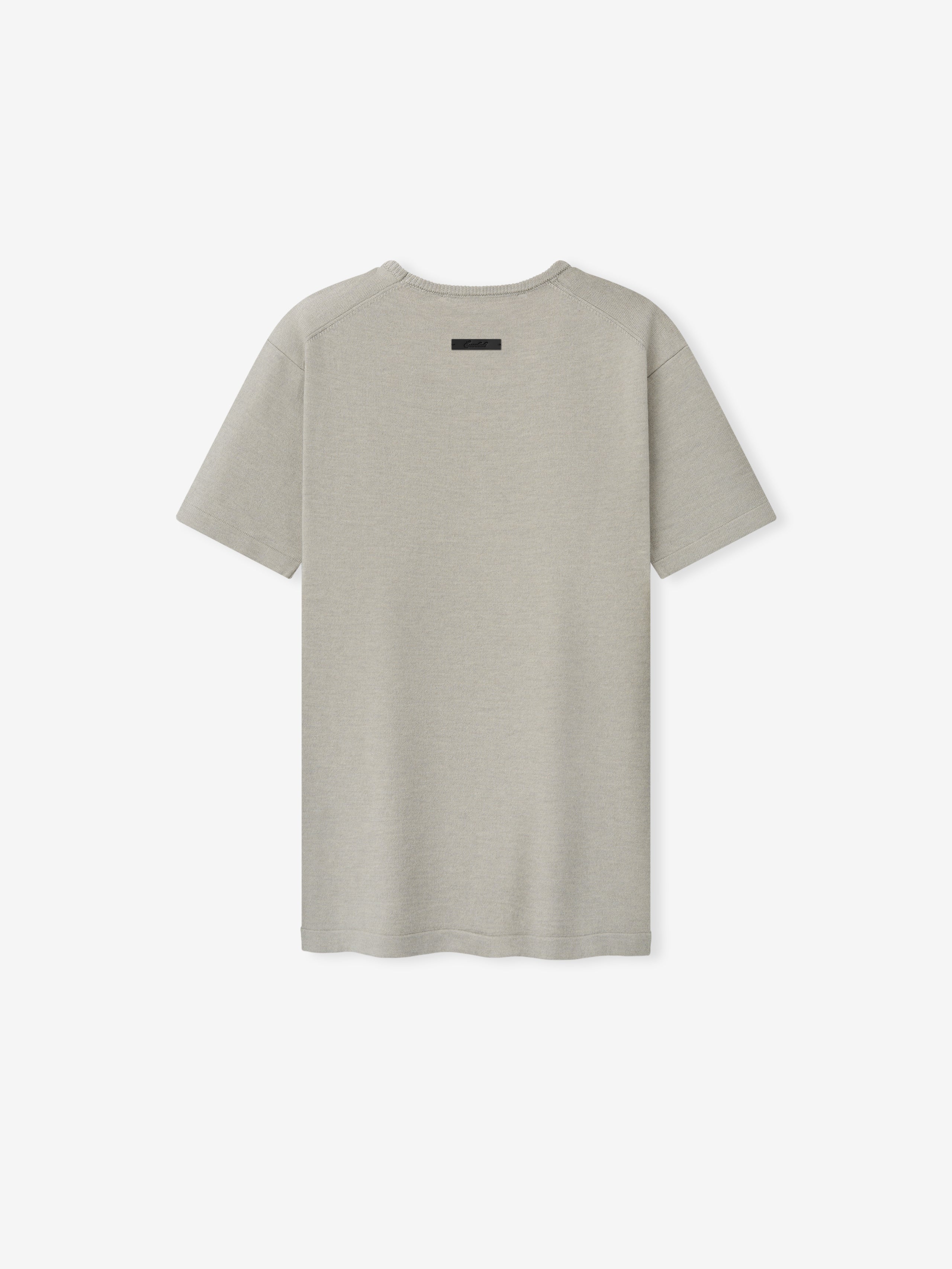 Womens Soft Knit Slim Classic Tee in a soft neutral shade, featuring a smooth knit fabric with a slim fit and a subtle branded detail at the upper back, designed for everyday casual tops.