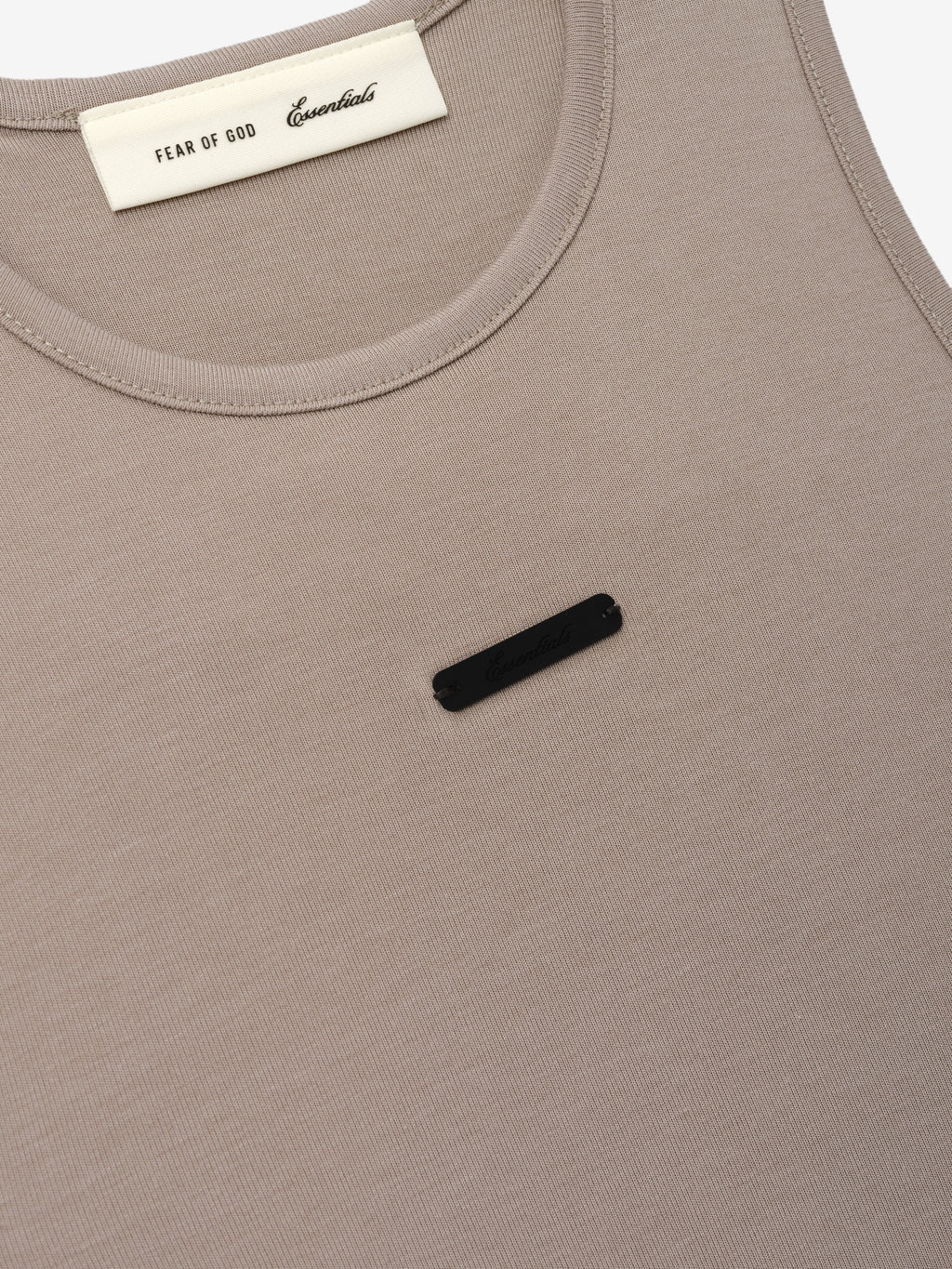 Soft Rib Racerback Dress in a muted taupe shade, featuring a smooth ribbed texture with a subtle black logo detail and a rounded neckline for a clean, minimalist style.