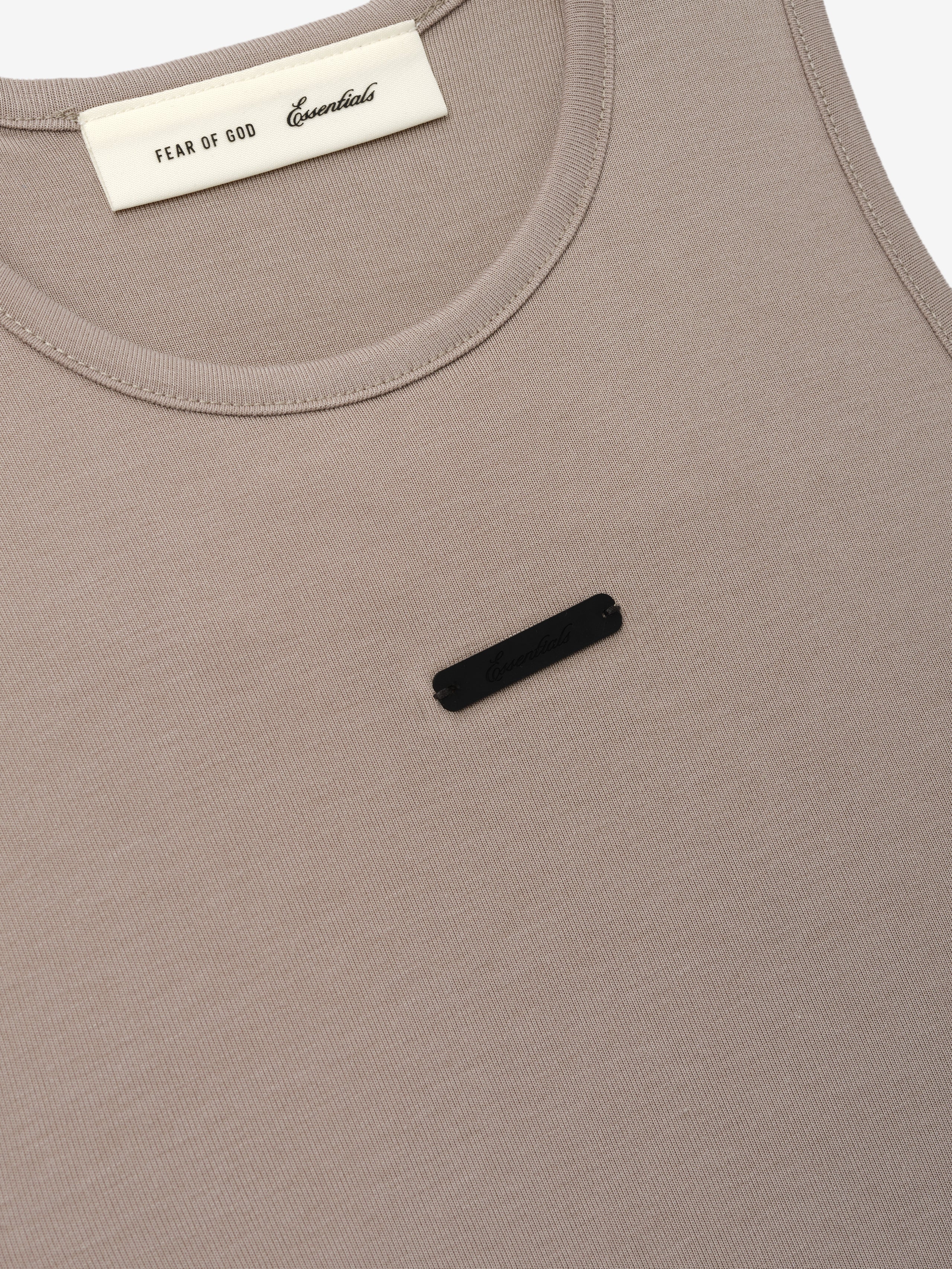 Soft Rib Racerback Dress in a muted taupe shade, featuring a smooth ribbed texture with a subtle black logo detail and a rounded neckline for a clean, minimalist style.