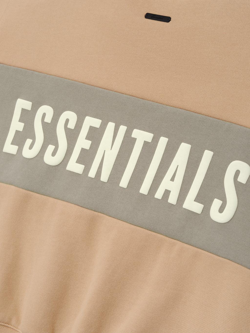 Womens Paneled Classic Sweatshirt in a warm ginger beige tone with a wide muted gray panel across the midsection, featuring bold white ESSENTIALS lettering on soft outerwear fabric.