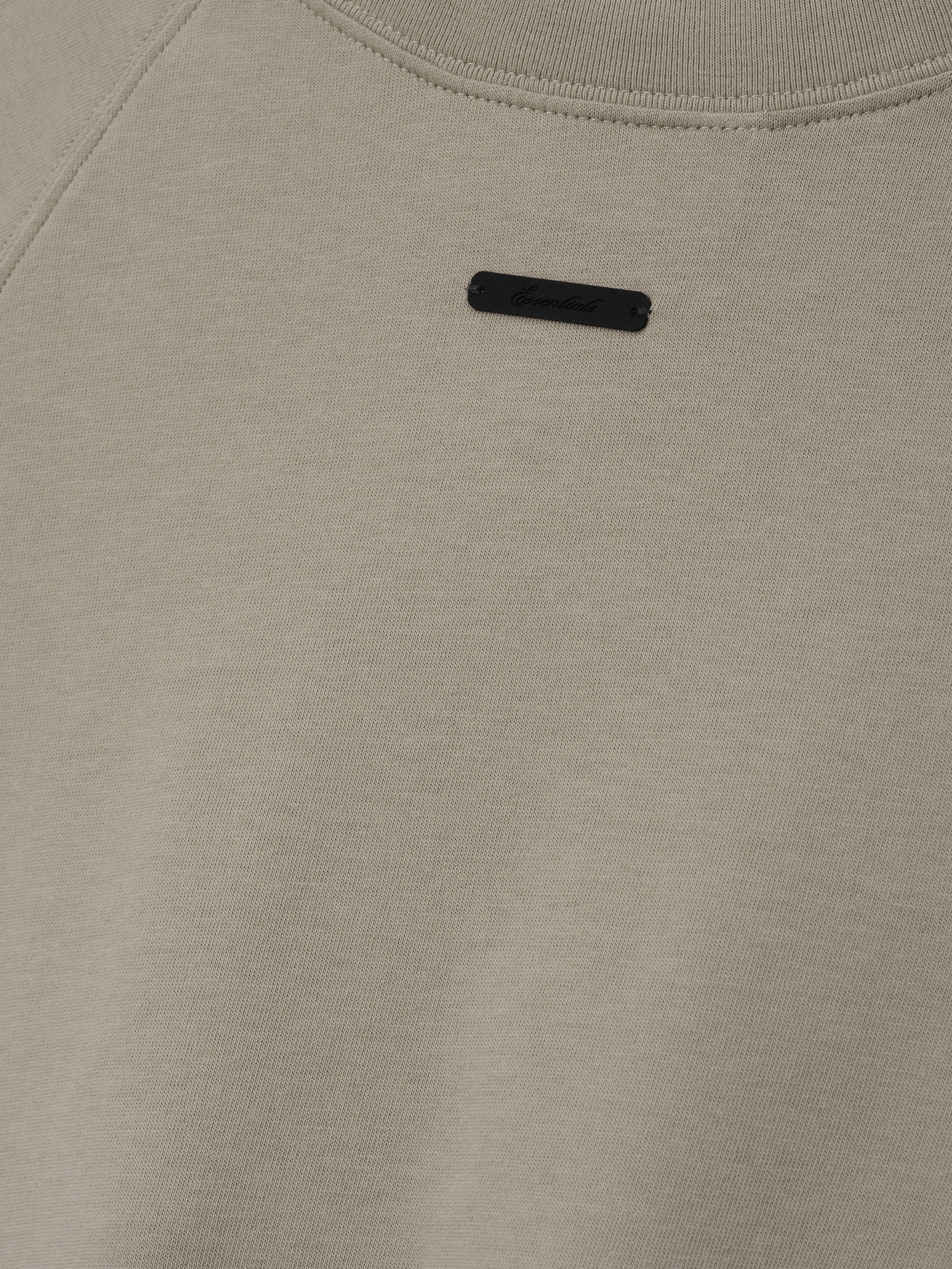 Womens Shrunken Baseball Tee in a muted seal green shade featuring a minimalist black branded patch on the upper back, crafted from soft fabric for casual tops.