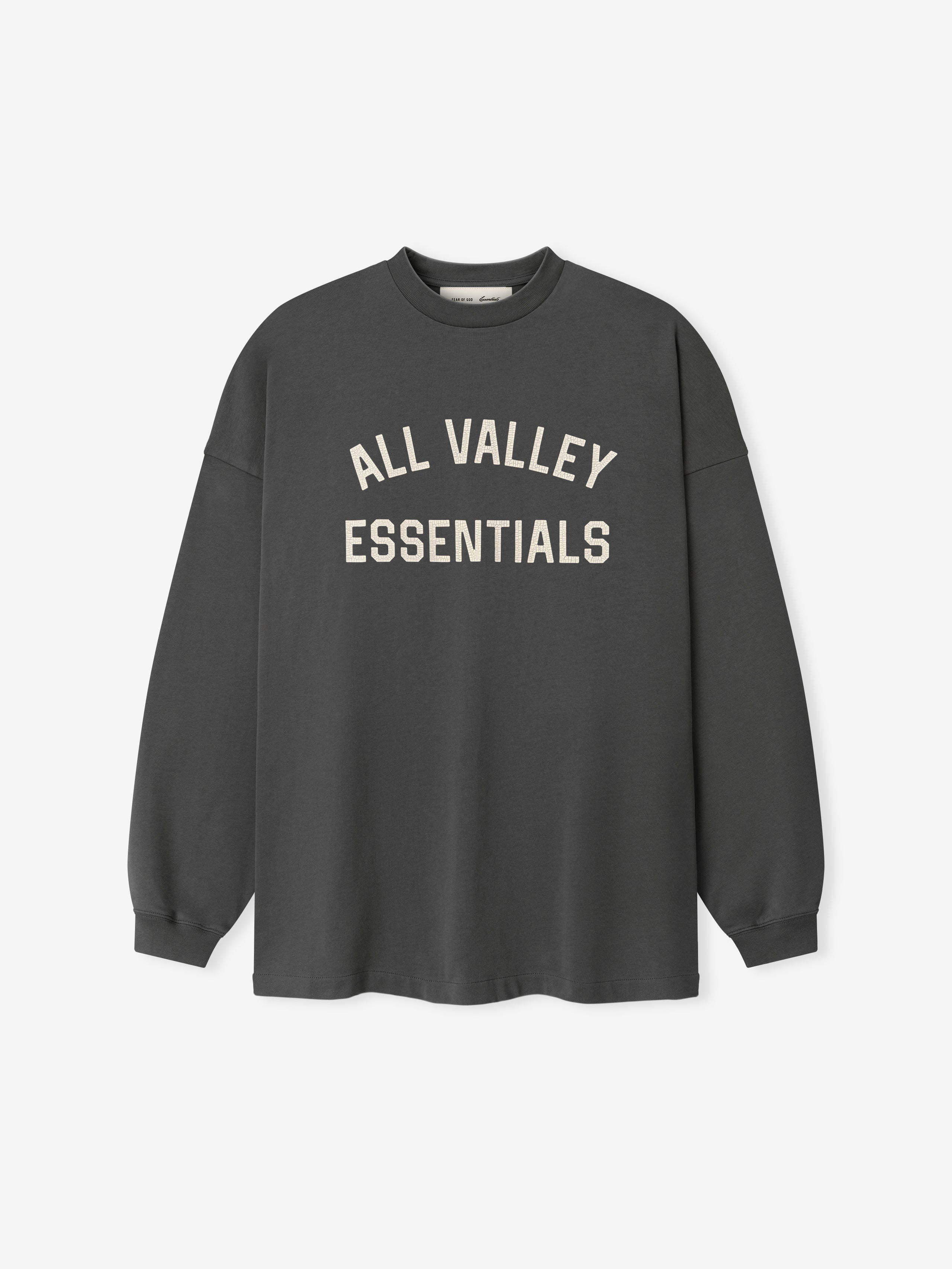 Merch Long Sleeve Tee in iron grey featuring soft cream "ALL VALLEY ESSENTIALS" lettering across the chest for a minimalist and casual top.