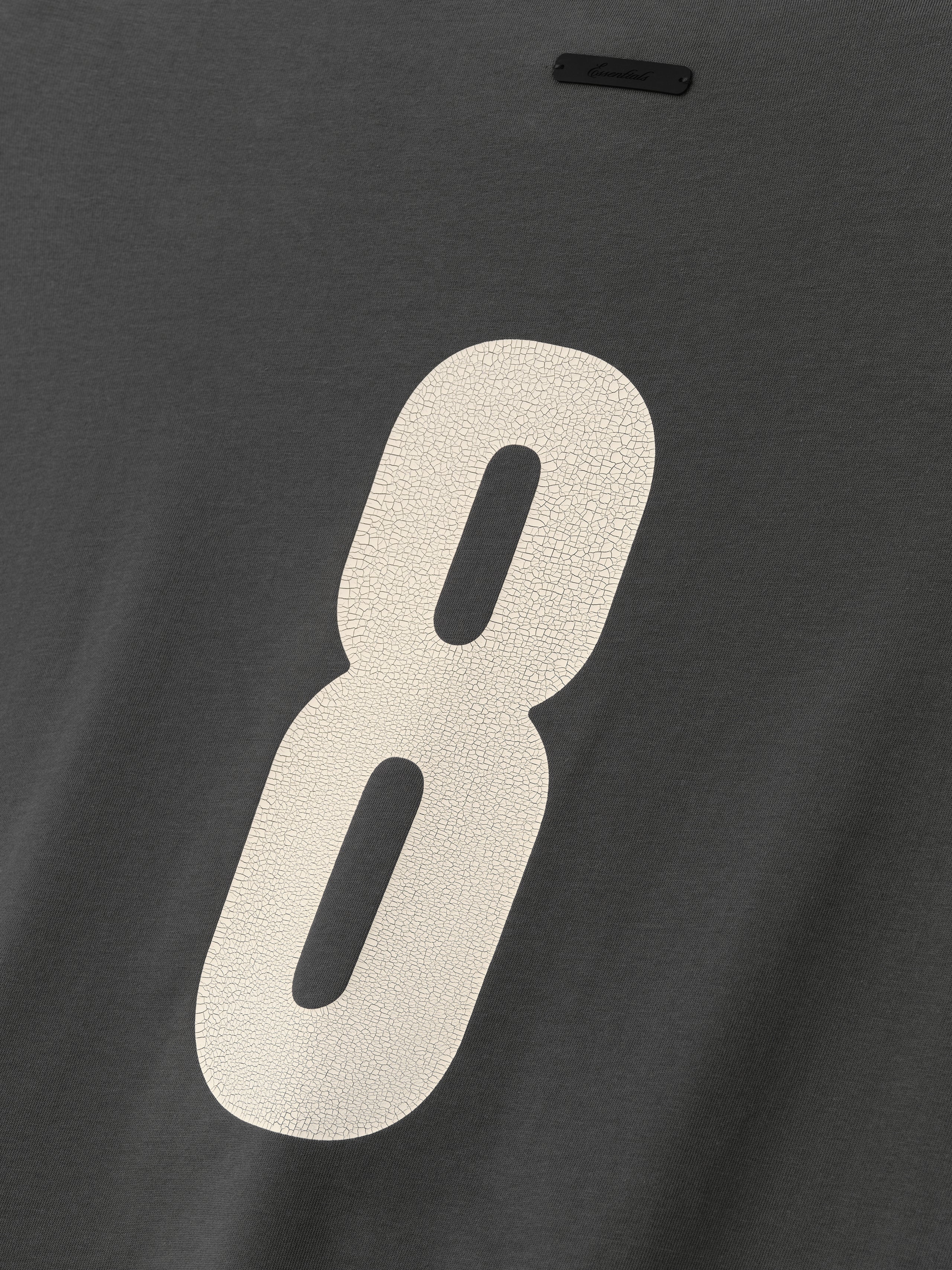 Merch Long Sleeve Tee in dark iron grey featuring a large cracked cream number 8 printed on soft fabric for a stylish and comfortable casual top.