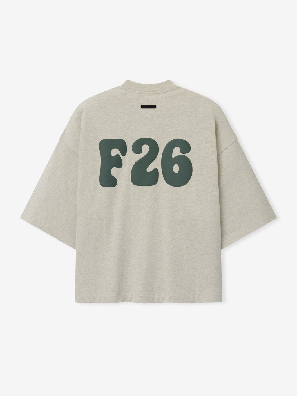 Merch Tee in soft neutral beige featuring relaxed fit and oversized dark green stylized "F26" lettering on the back for a modern casual top.